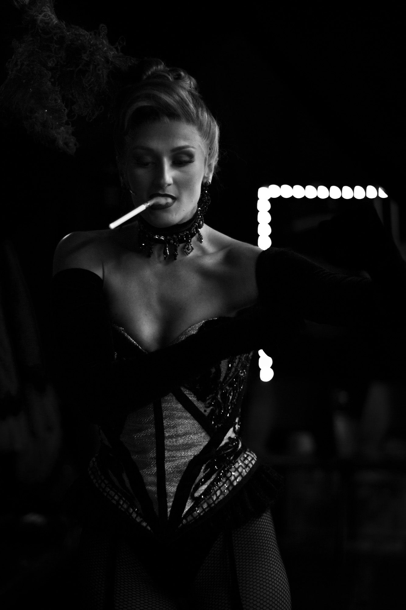Black and white image of one of a performer at Moulin Rouge! The Musical in London. Backstage image of a performer moments before the show.