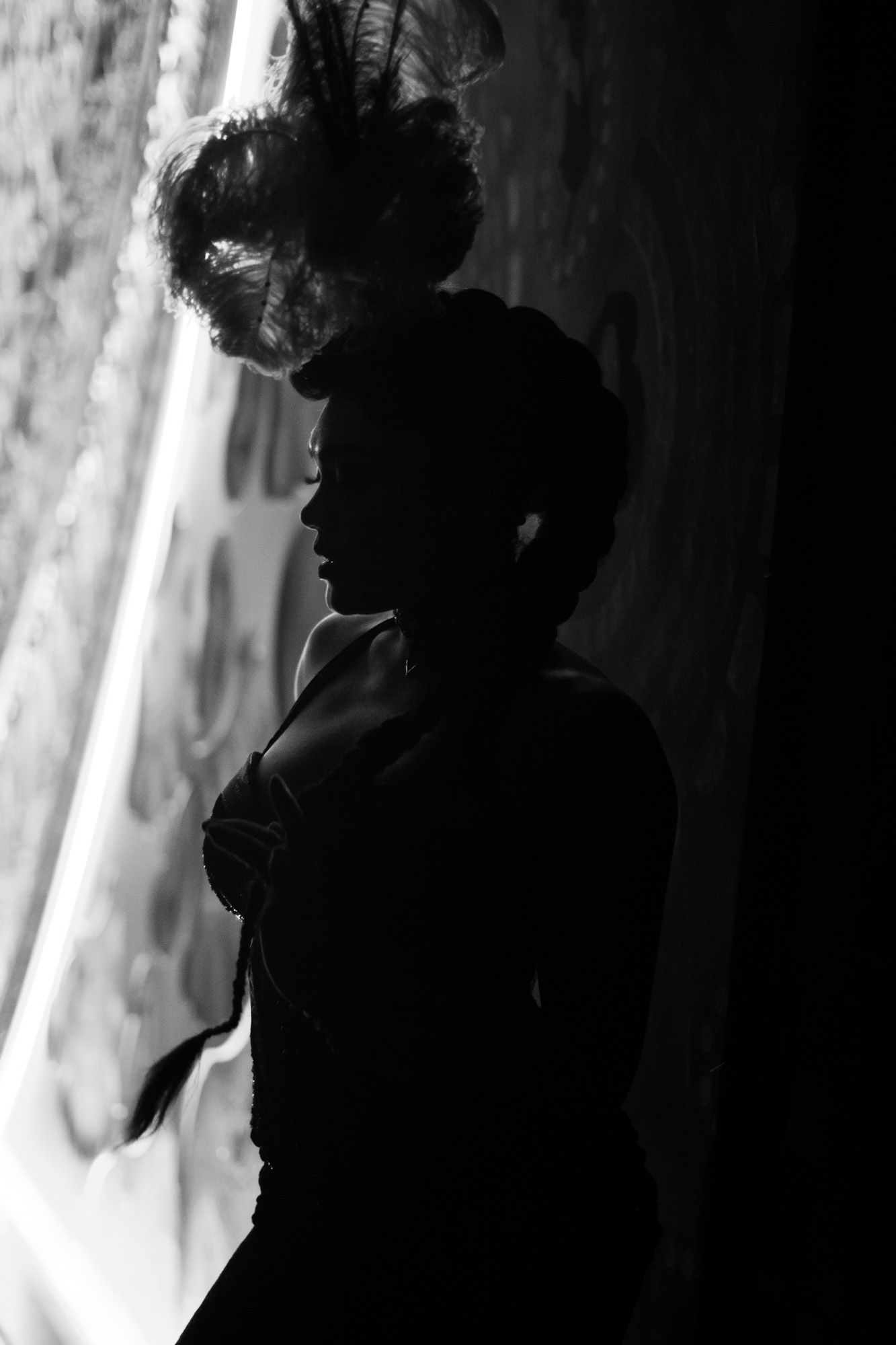 Black and white image of one of a performer at Moulin Rouge! The Musical in London. Backstage image of a performer waiting in the wings.