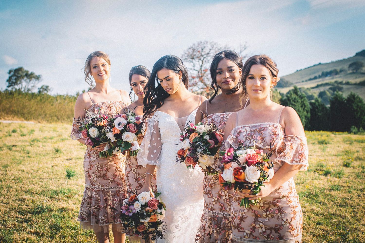 Dramatic pastoral landscape shot near Kiama used for winter wedding portraits of bride, maid of honour and bridesmaids.