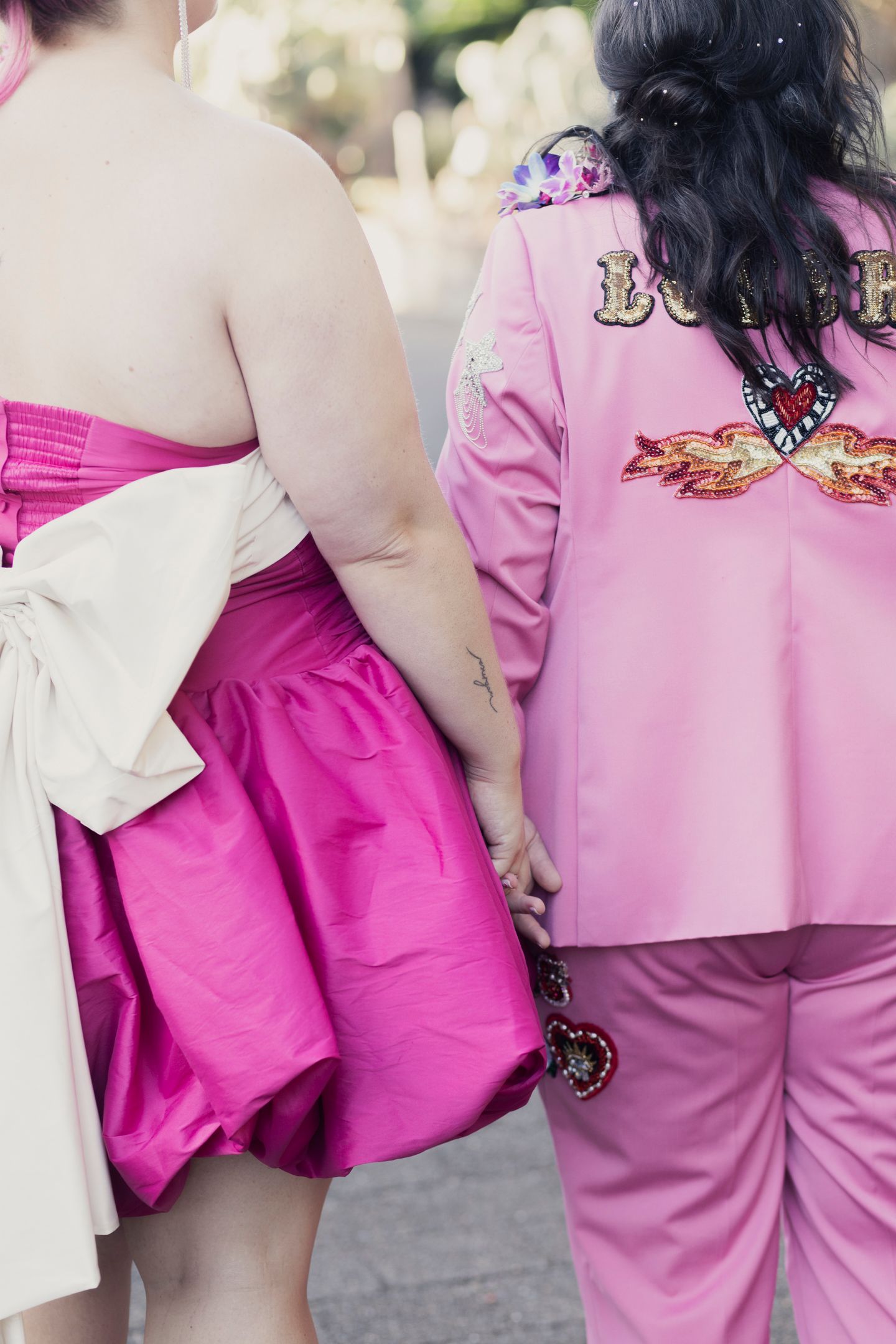Artistic portrait of the brides embracing in the Royal Botanic Garden Sydney by Koco Weddings.