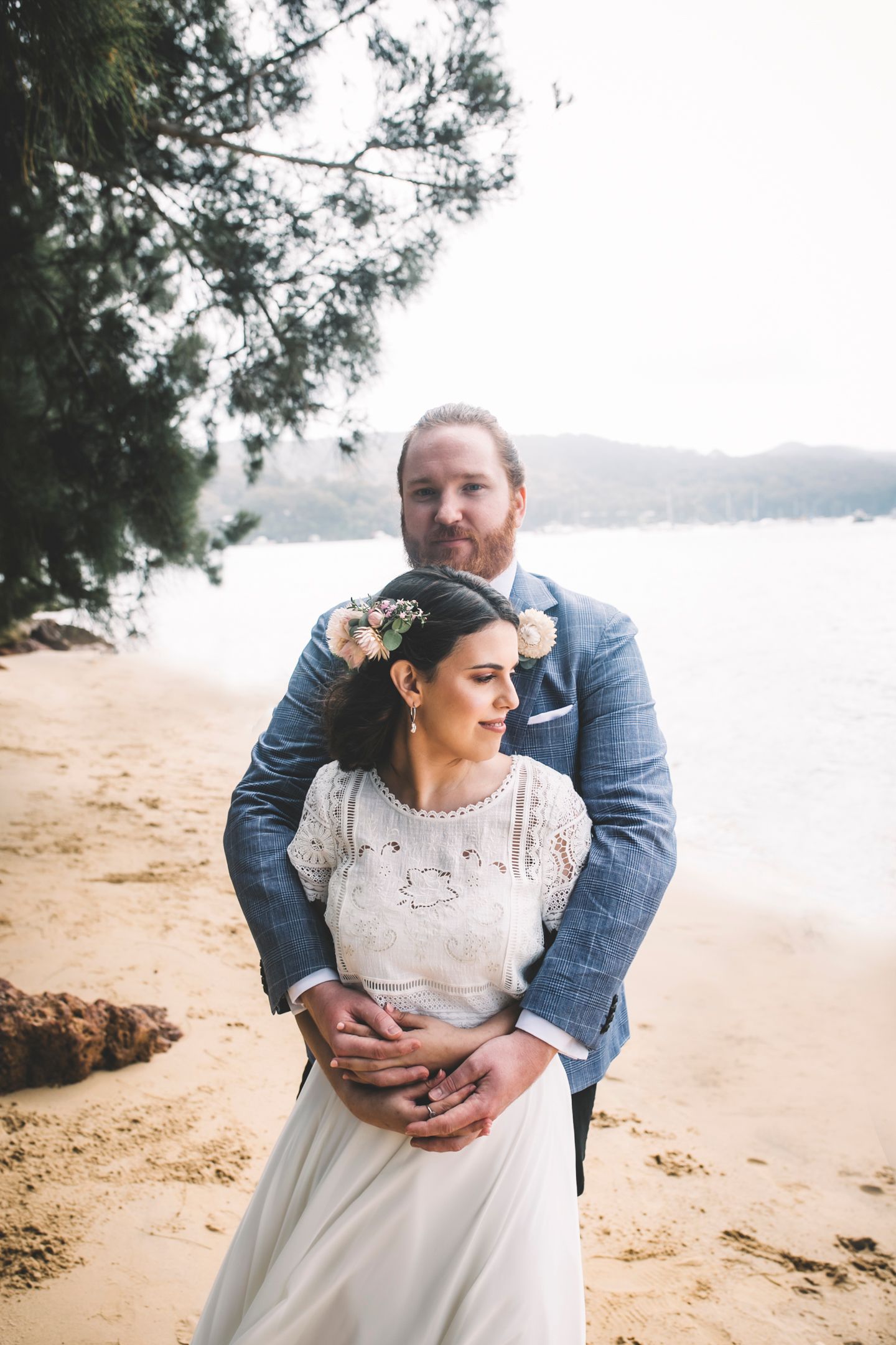 Golden hour portrait of the couple by the water at Church Point by Koco Weddings.