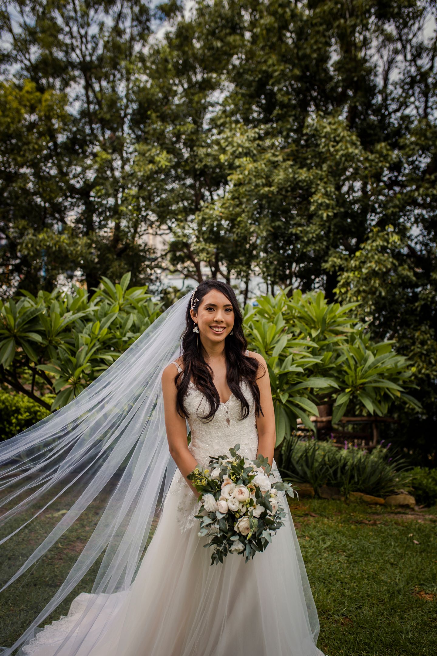 Editorial portrait showing the lace detail of the Oleg Cassini wedding dress in soft light.