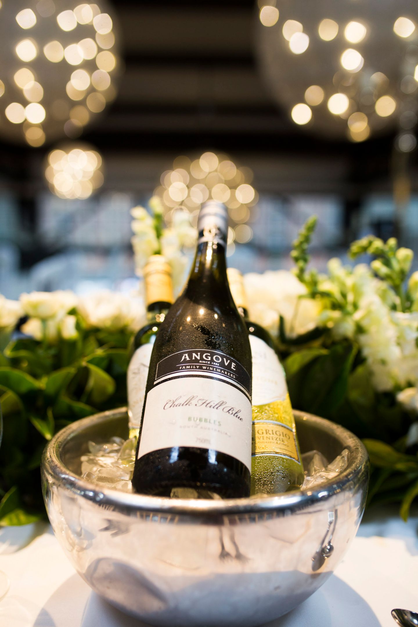 Luxurious black-tie reception table setting inside Doltone House with city views.