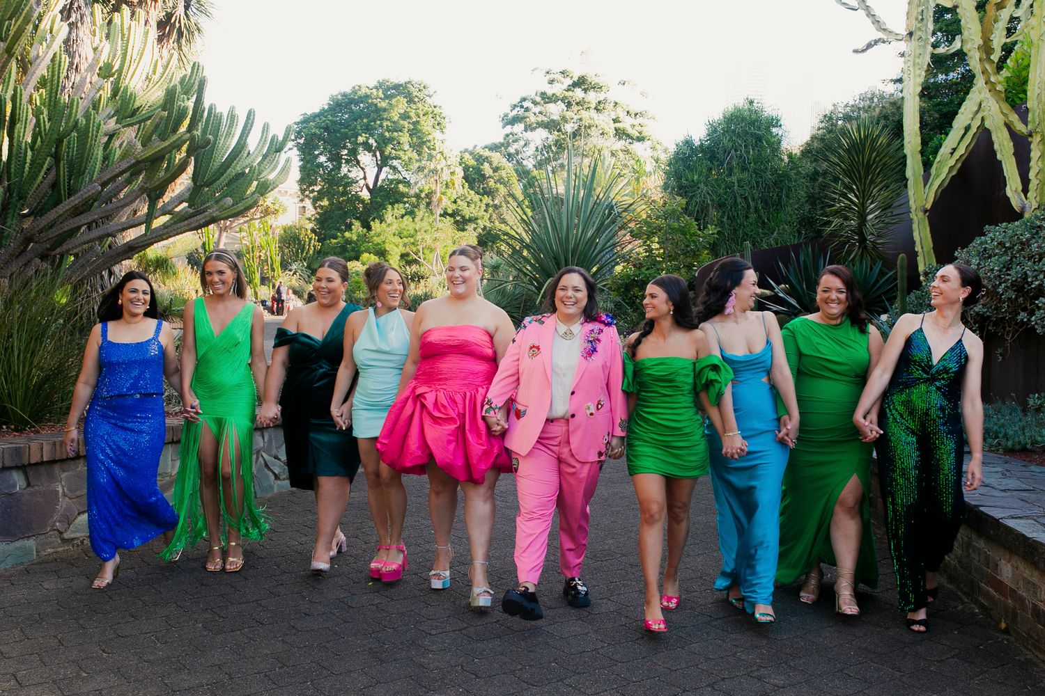 Vibrant, high-fashion group photo of the VIP bridal party on the steps of the Sydney Botanical Gardens.