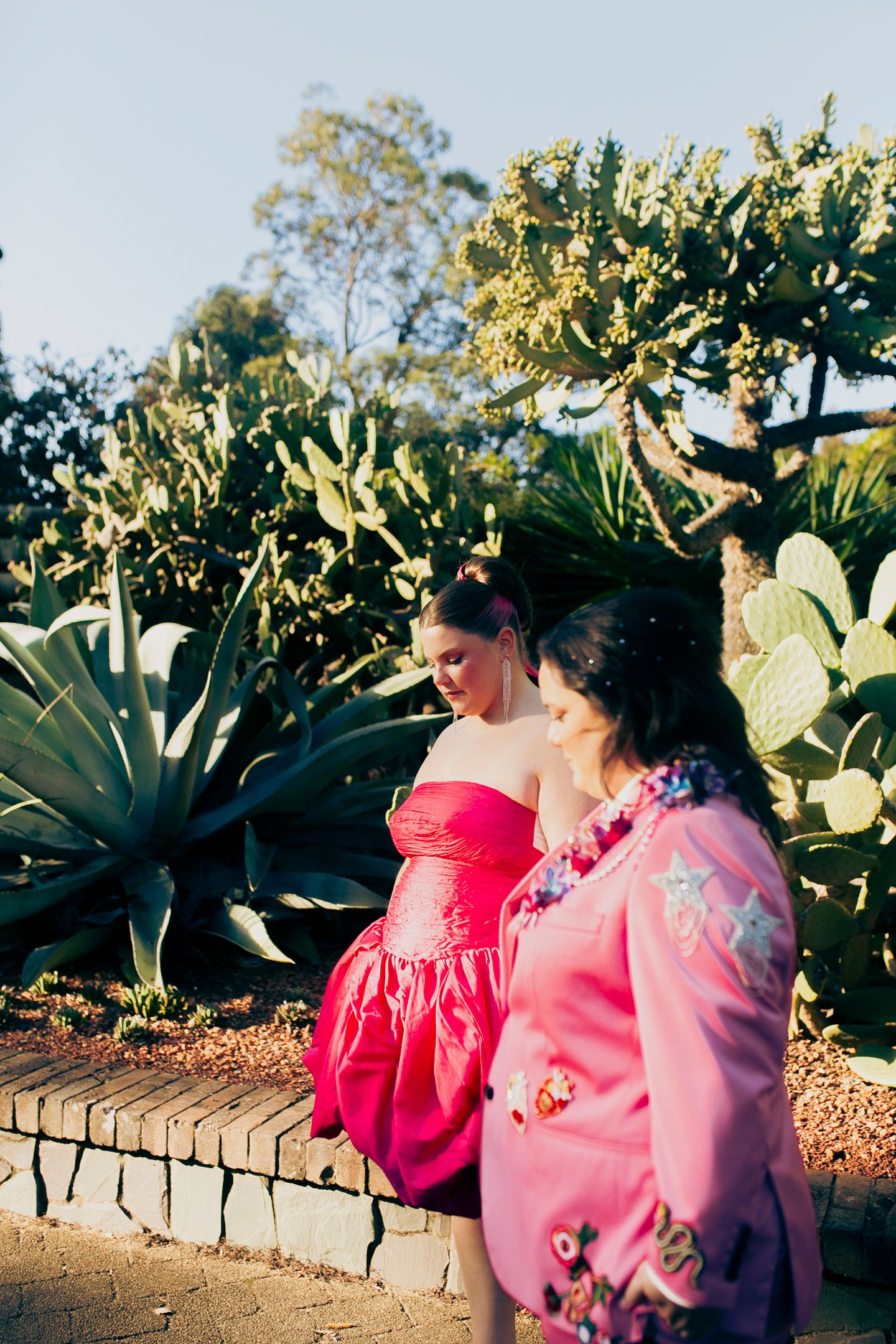 Artistic portrait of the brides embracing in the Royal Botanic Garden Sydney by Koco Weddings.
