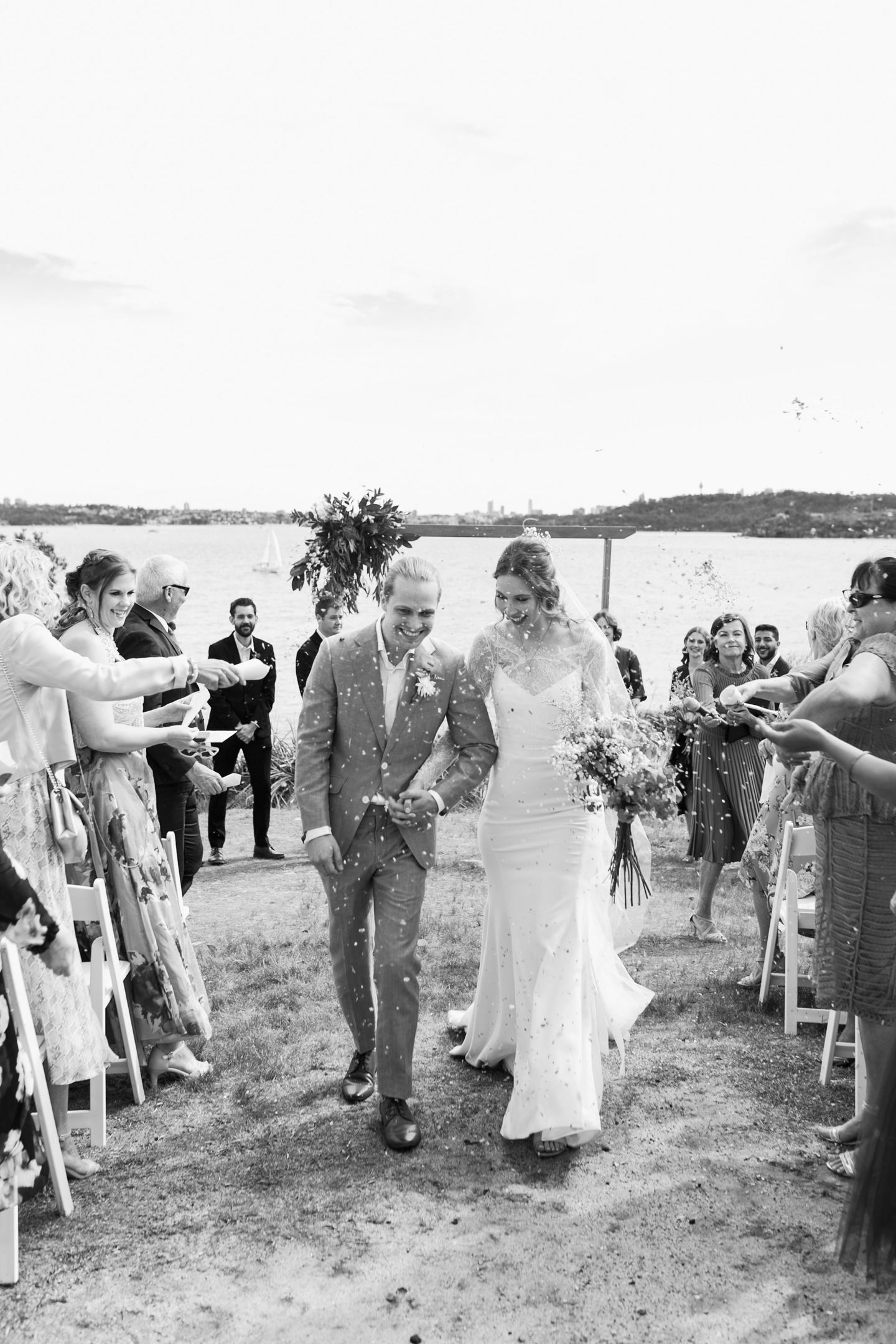 Candid laughter shared between the couple during coastal bridal portraits.