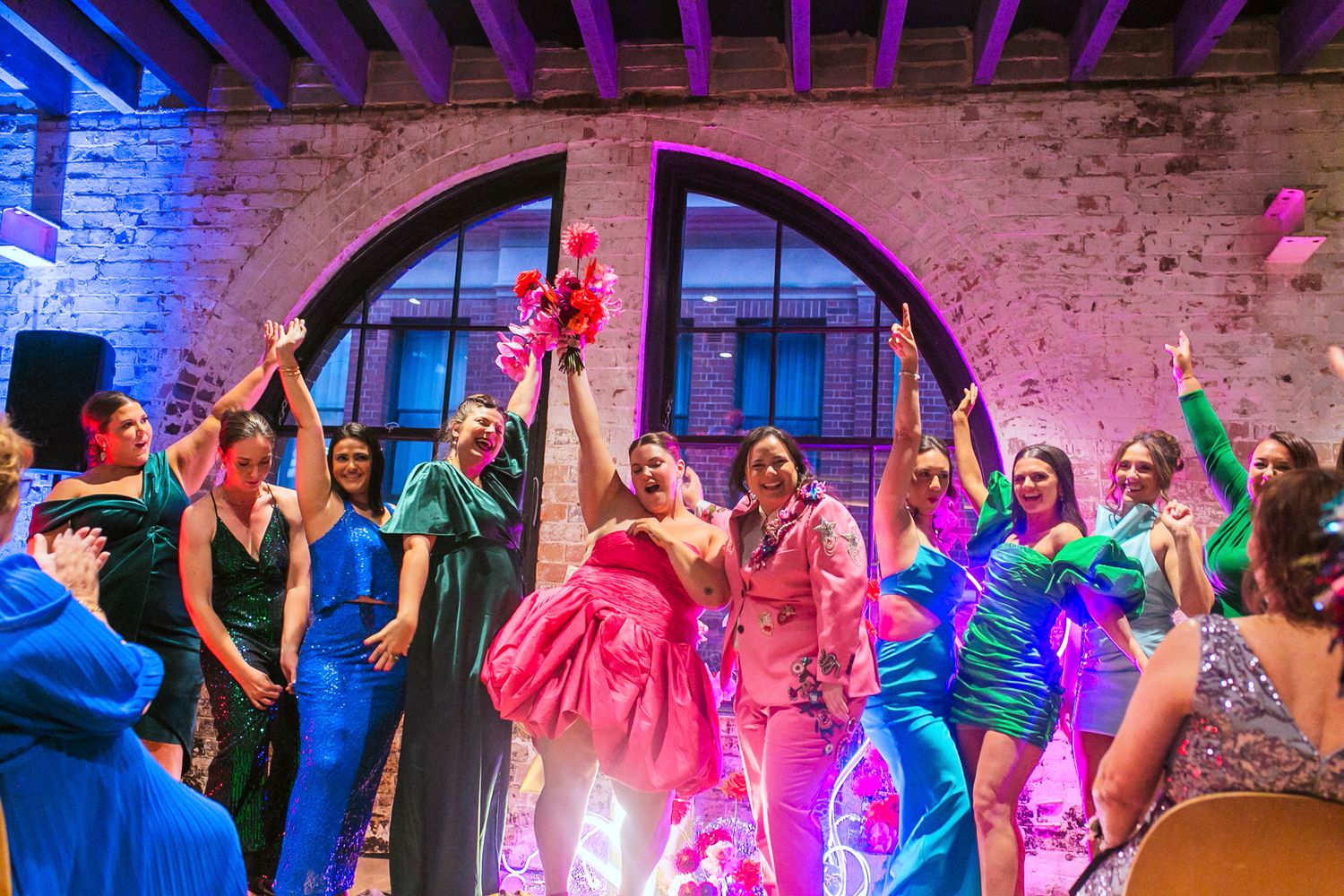 The bright, industrial-chic interior of Olio Kensington Street set for a colourful reception.