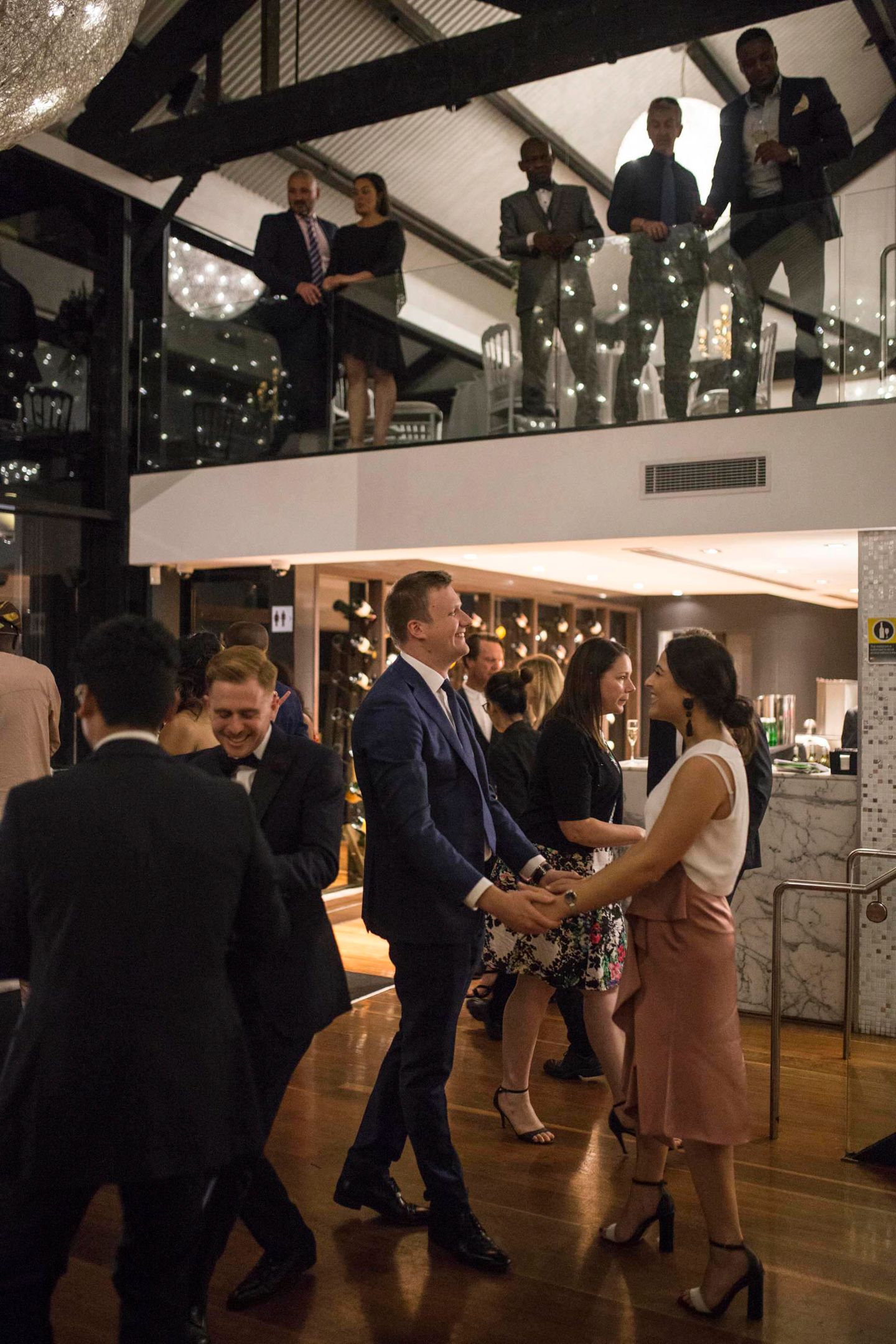 Vibrant dance floor energy at a luxury Sydney waterfront wedding reception.