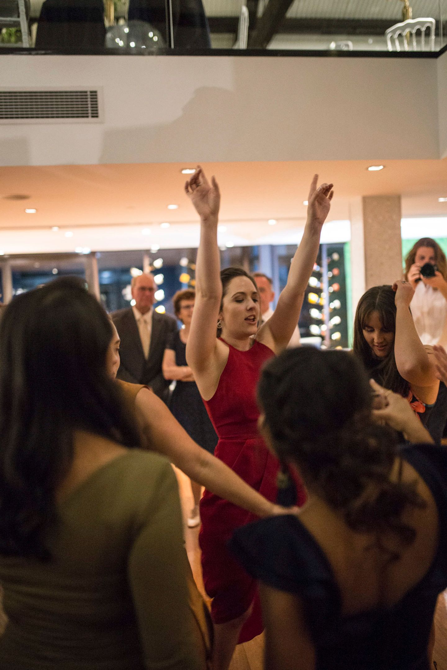 Vibrant dance floor energy at a luxury Sydney waterfront wedding reception.