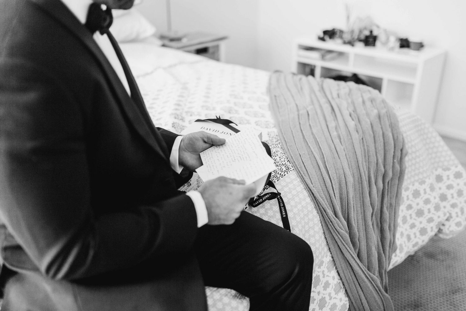 Classic black and white photo of the groom’s Peter Jackson tuxedo details.