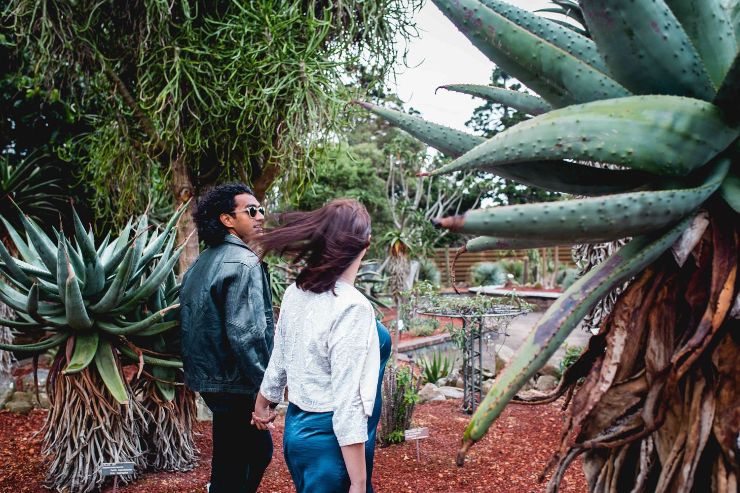 Candid shot of Eric and Julia walking through the Botanic Gardens in winter.