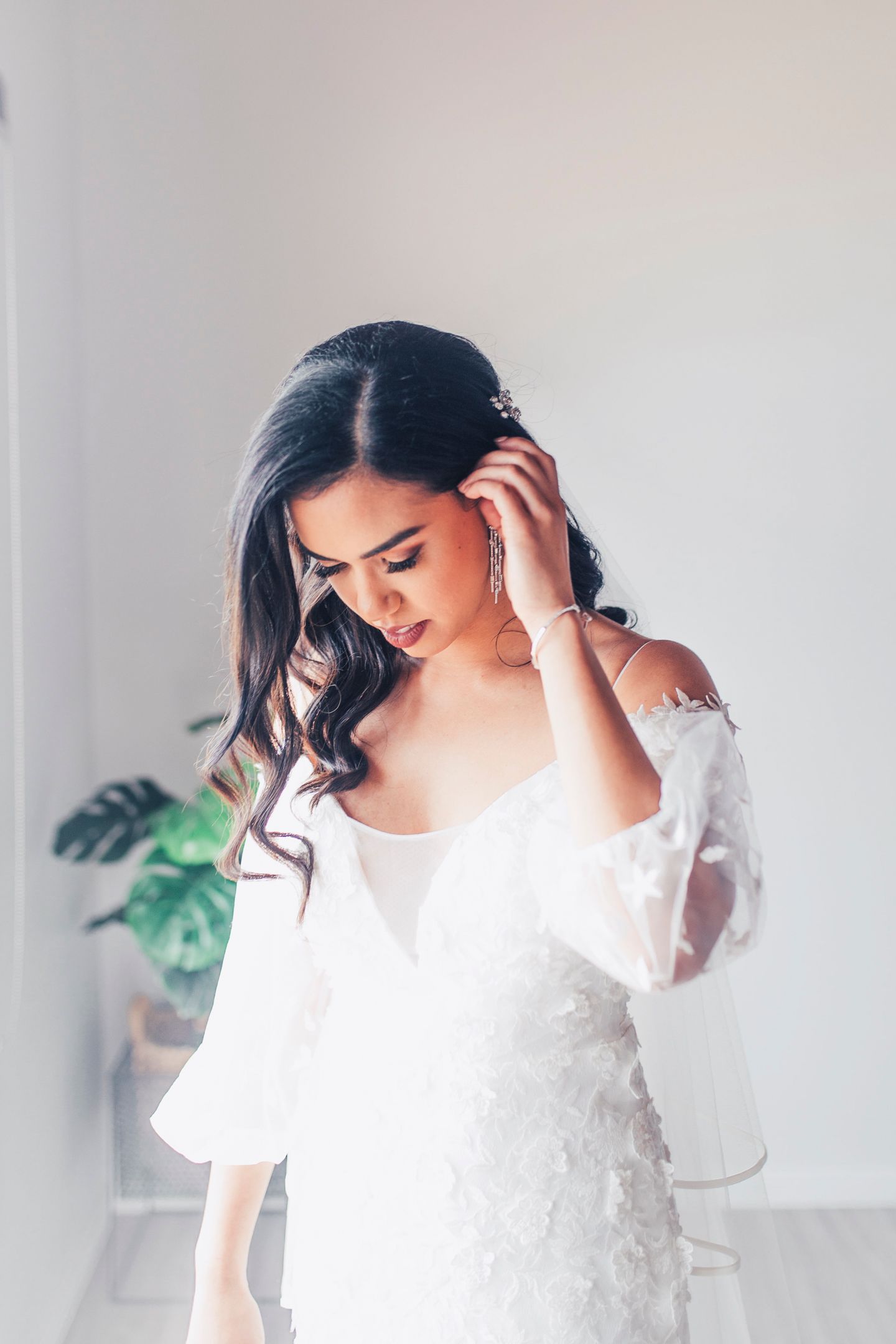 Editorial shot of the bride in her Tara Lauren gown with a floral lace wrap in winter.