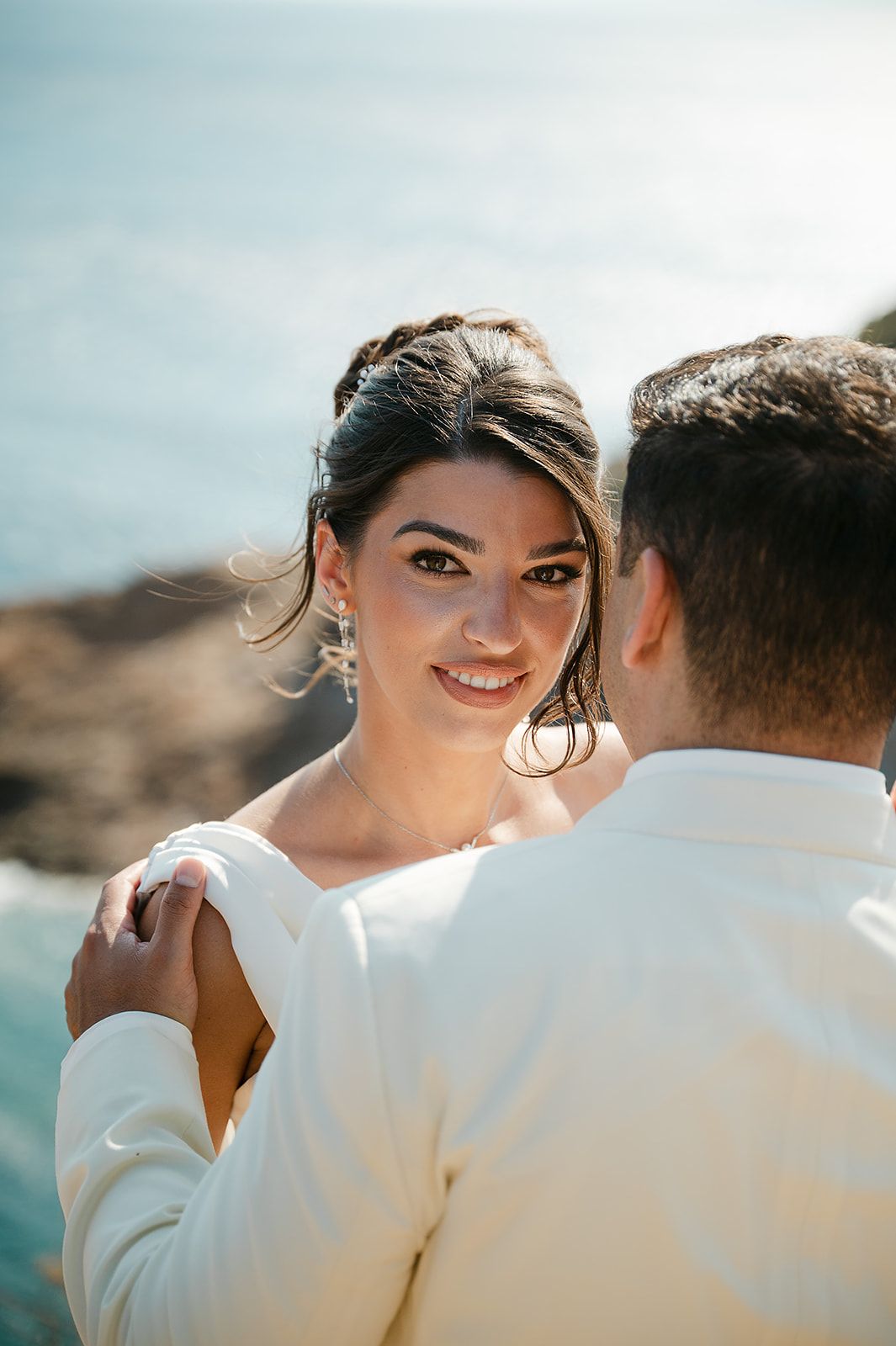 A couple shares an intimate moment on a beach with soft lighting and a dreamy atmosphere at Ktima 48 Athens