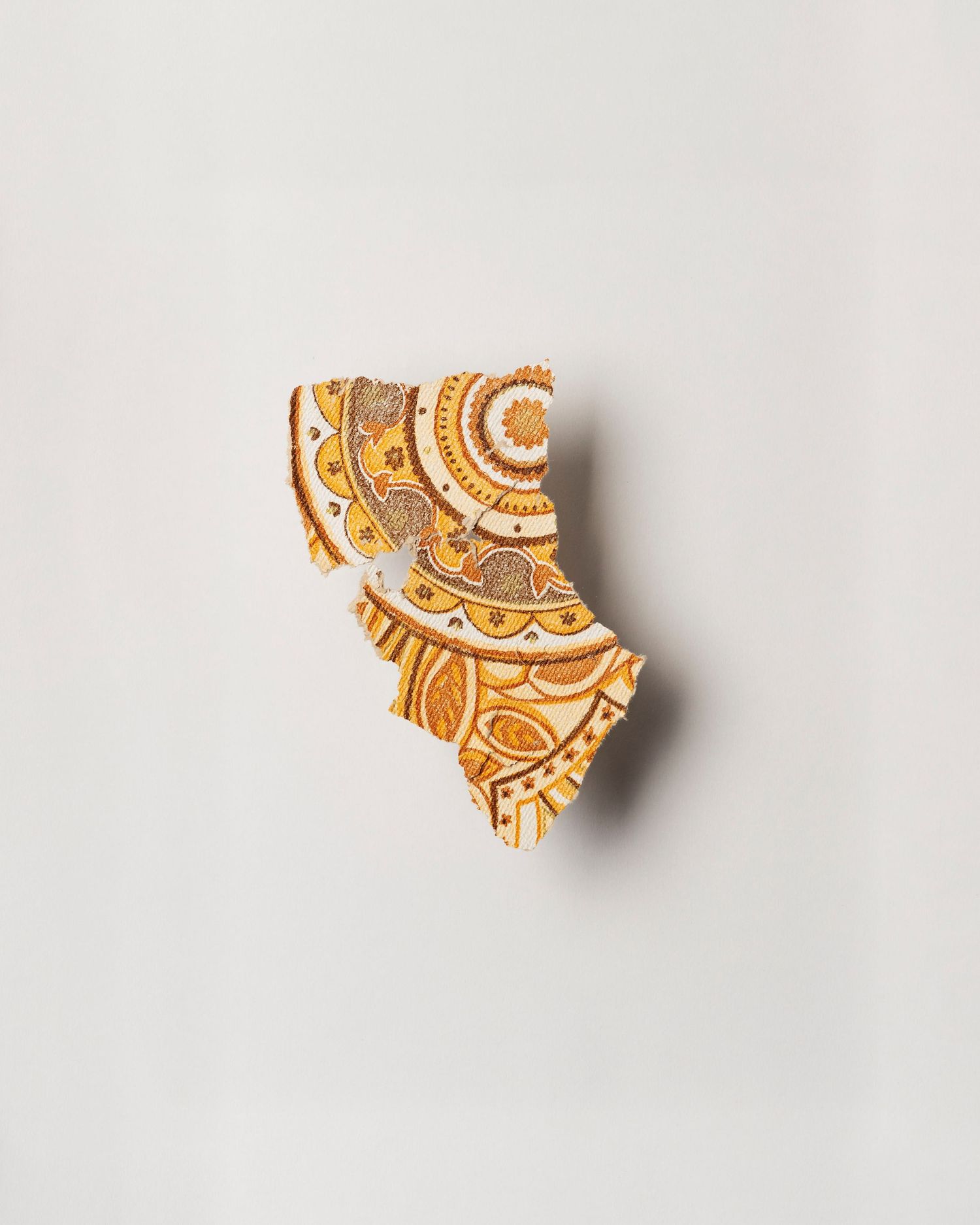 A fragment of wallpaper; yellow and brown circular shapes