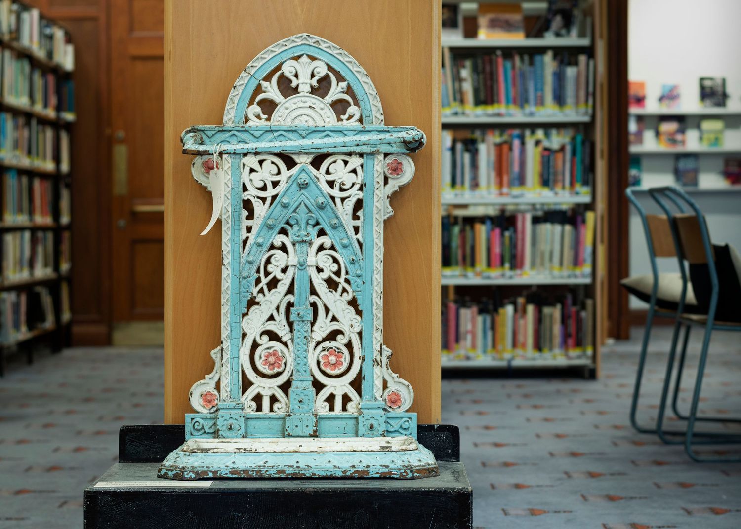 An umbrella stand painted in the colours used to represent the Suffragette movement