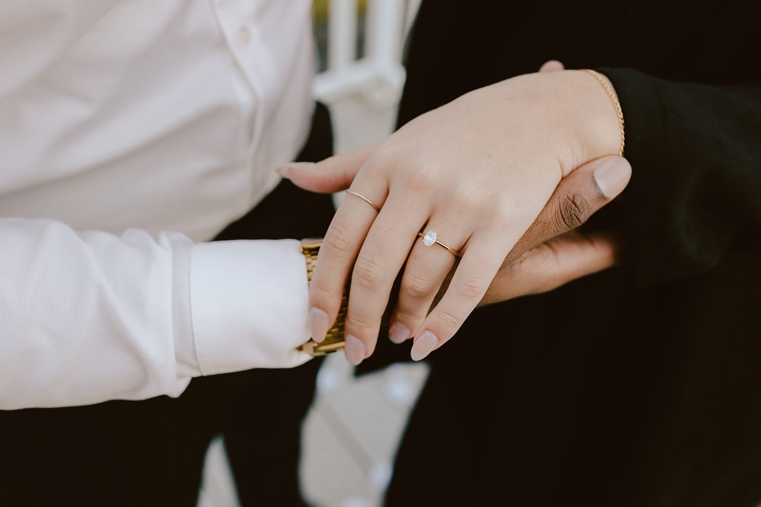 Close-up of a couple exchanging wedding rings during a ceremony, showcasing a diamond engagement ring.