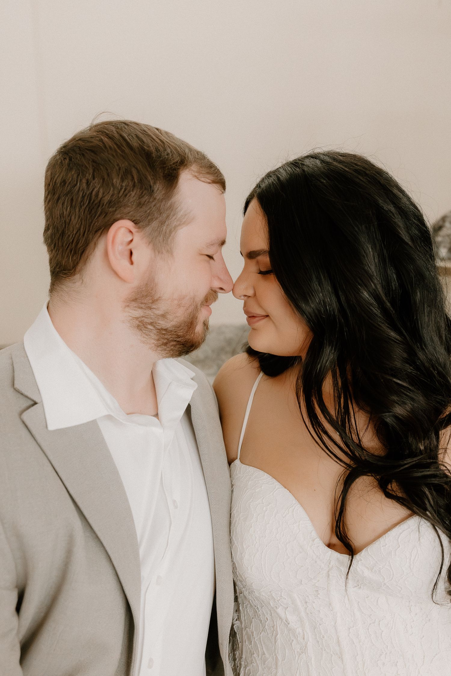 Bride and groom share an intimate nose-to-nose moment in close wedding portrait.