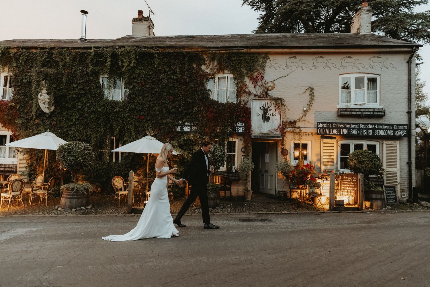 Bride and groom walking outside the The Roebuck Inn Wedding on their wedding day