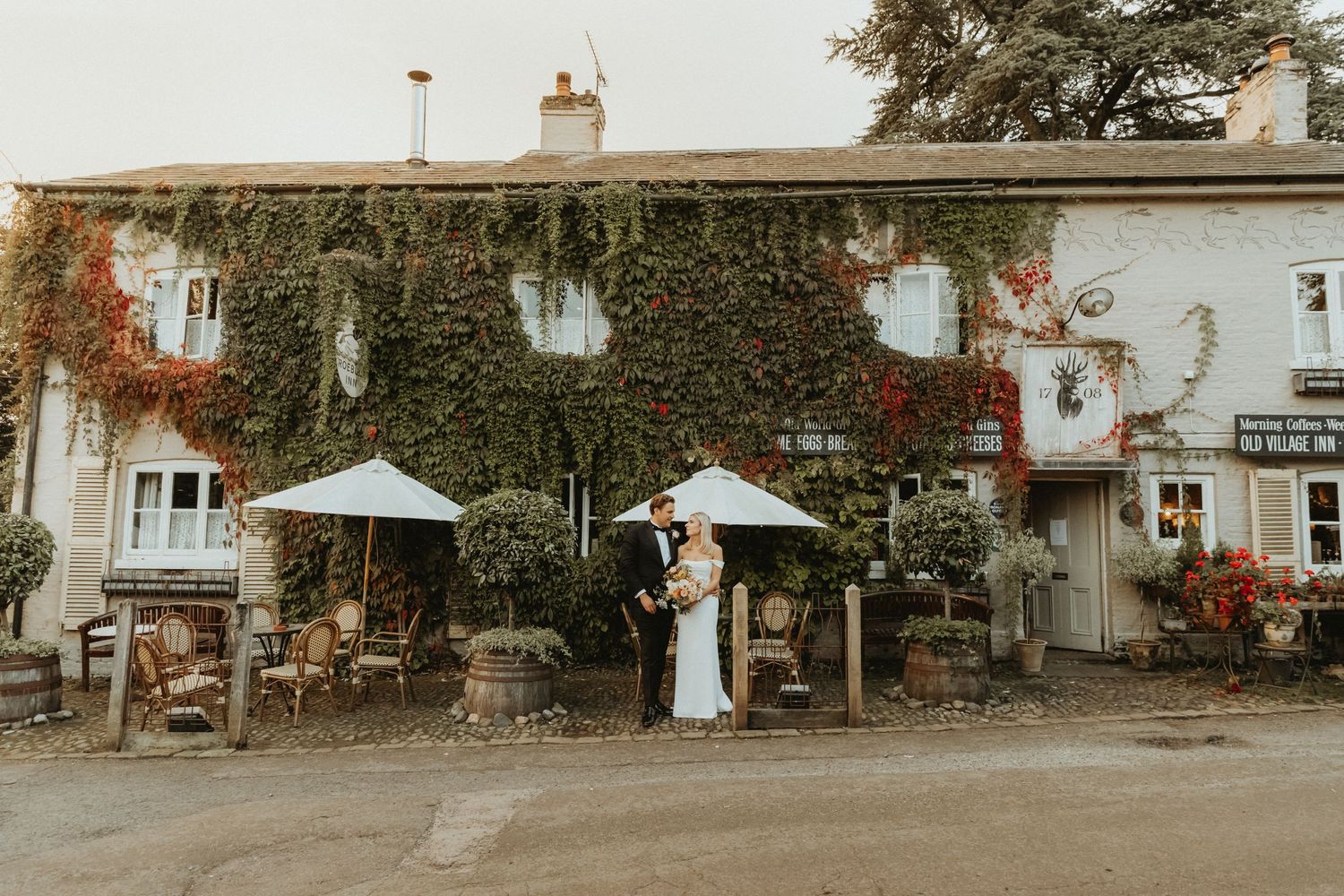 Bride and groom standing together outside The Roebuck Inn