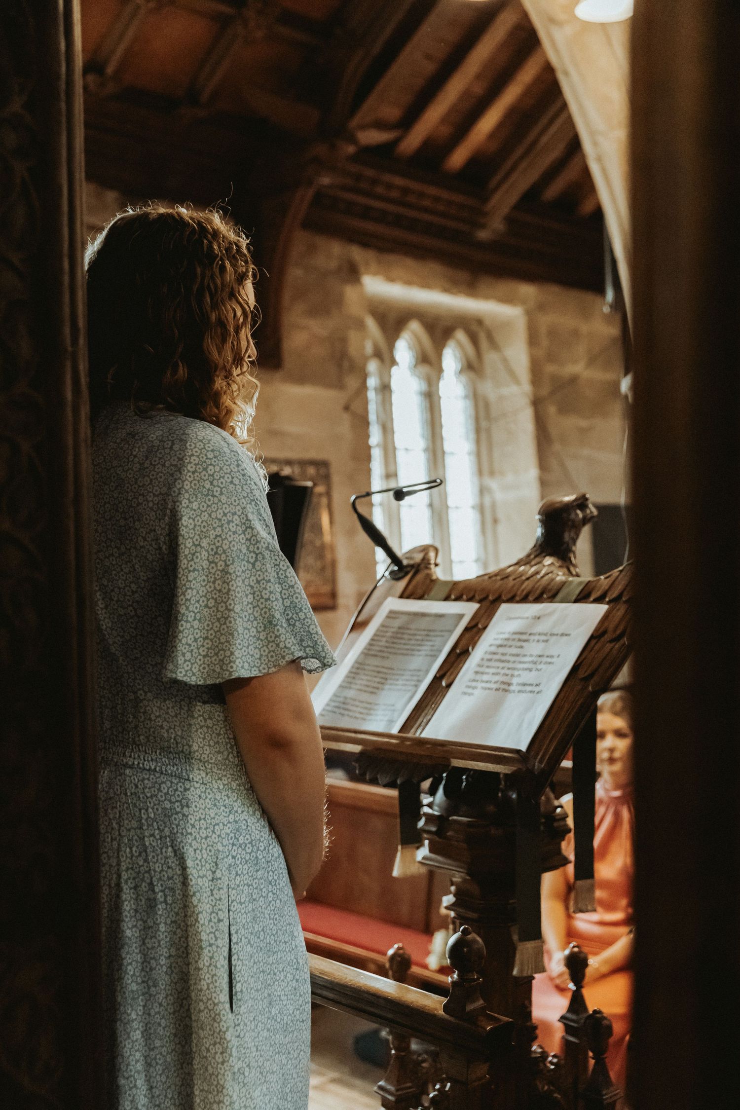 Family member standing in front of church saying a poem for the bride and groom