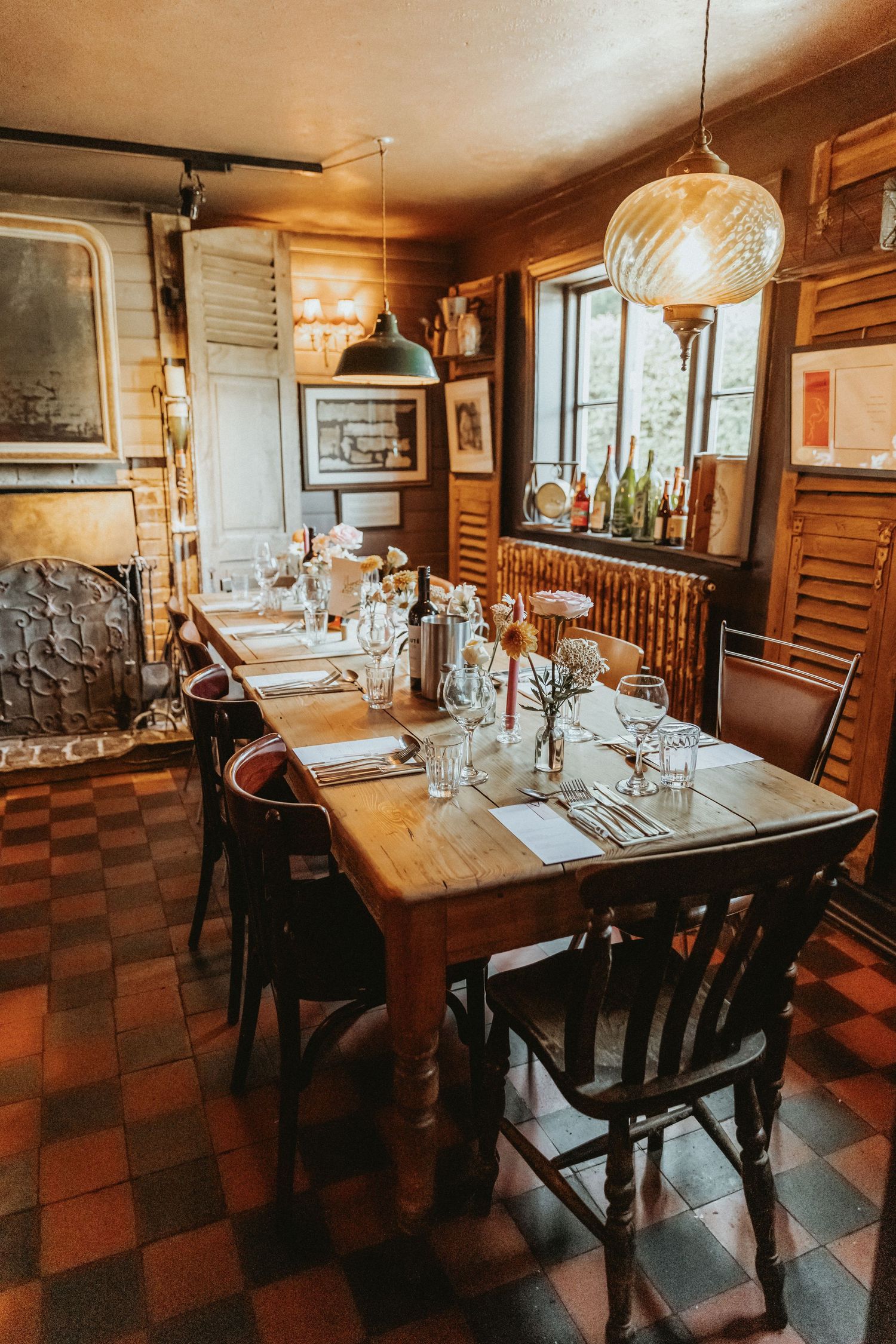 Interior of The Roebuck Inn set for dining with flowers on the table