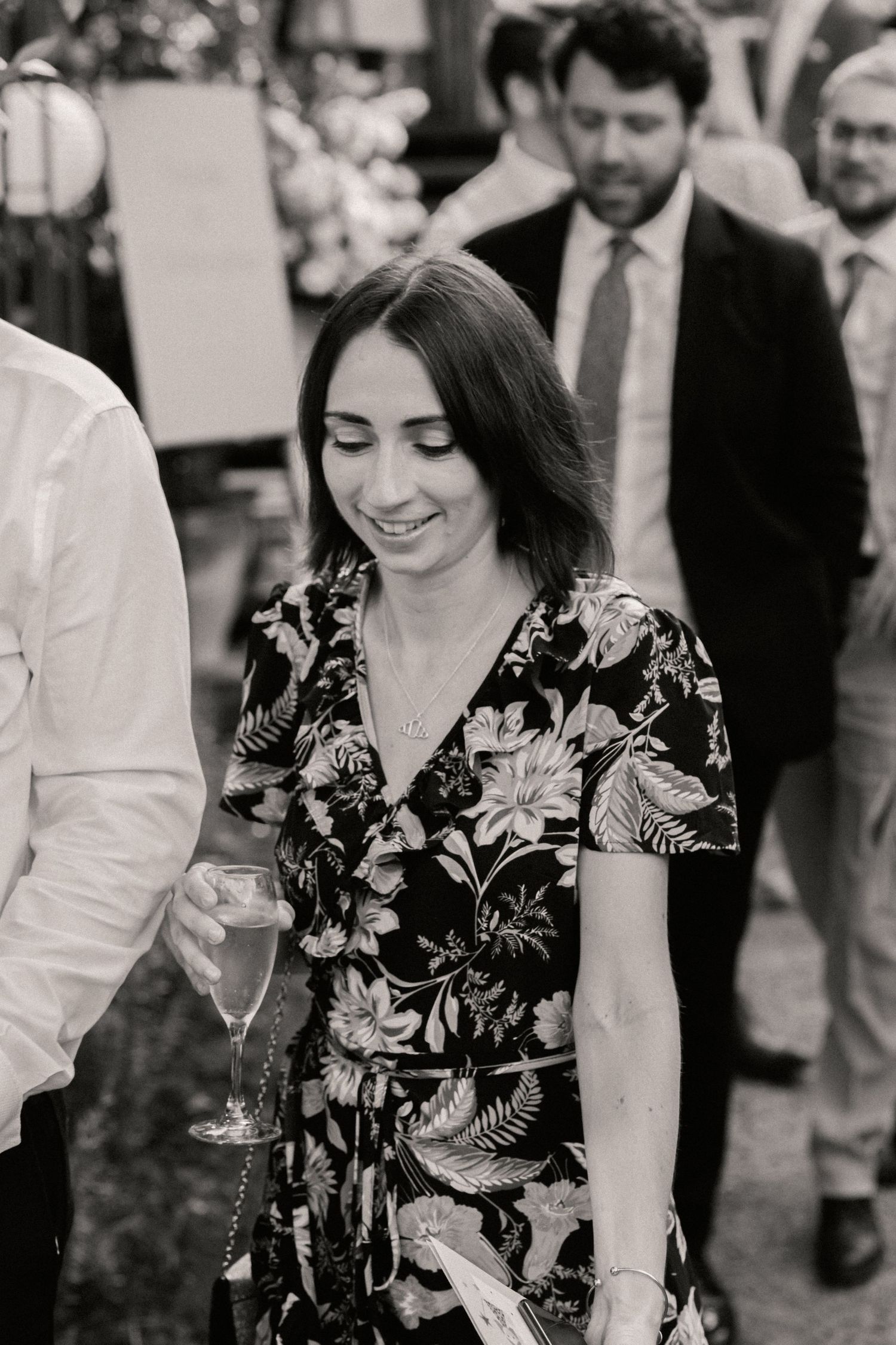 Guest at wedding walking with champagne flute in hand