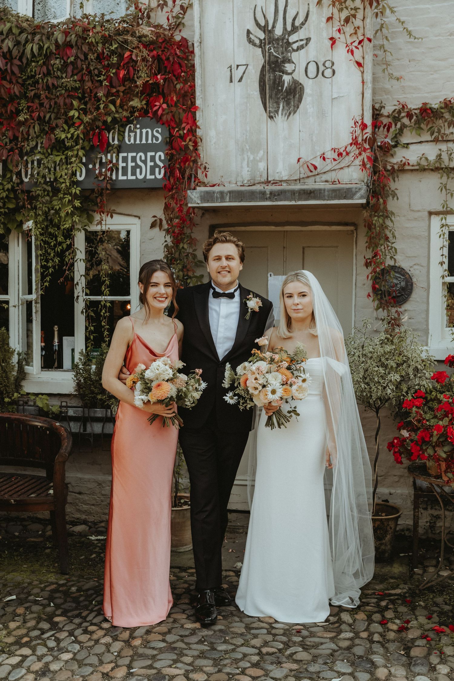 Bride and groom standing with relative outside the Roebuck Inn