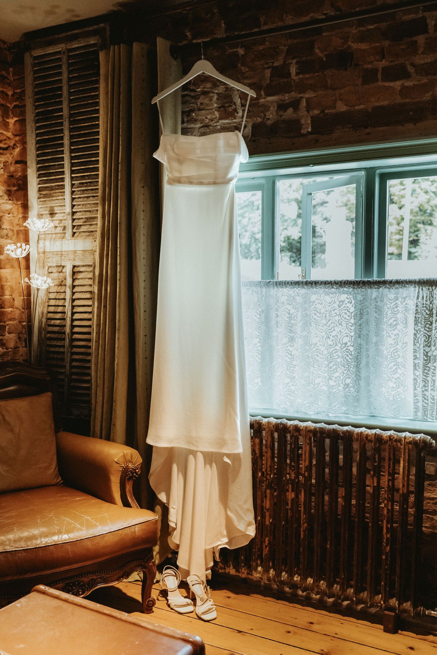 Brides dress hanging up in room at The Roebuck Inn