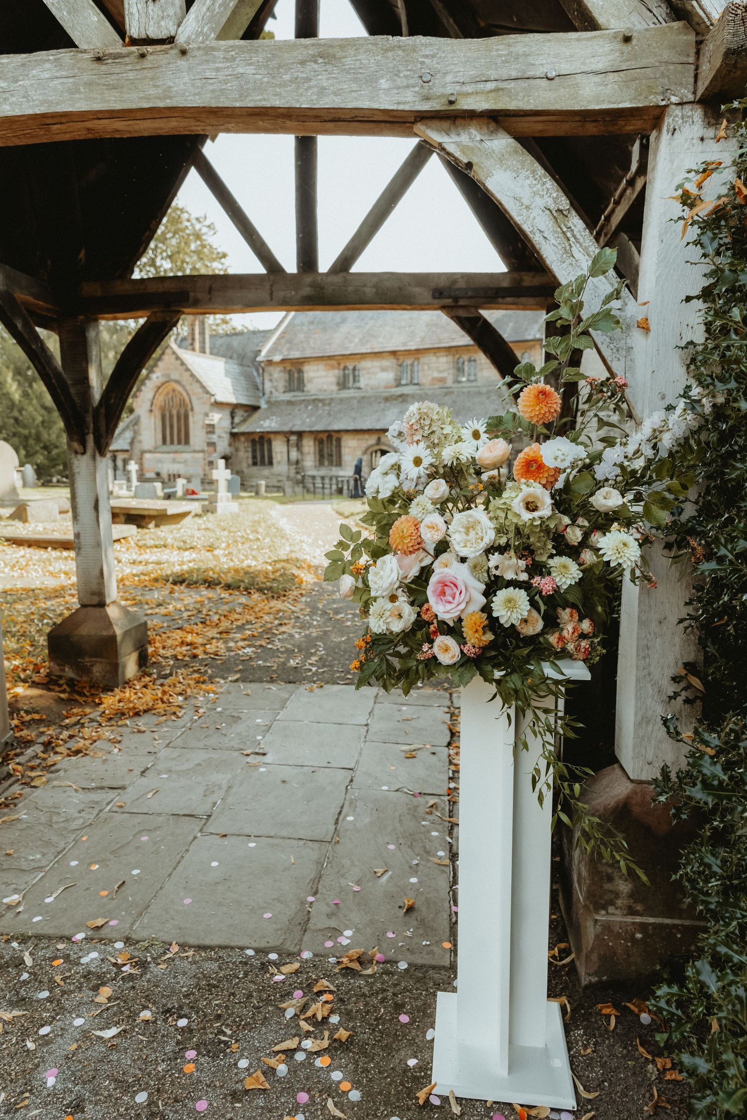 A mixture of different flowers arranged on stand outside of St Wilfrids church after wedding service