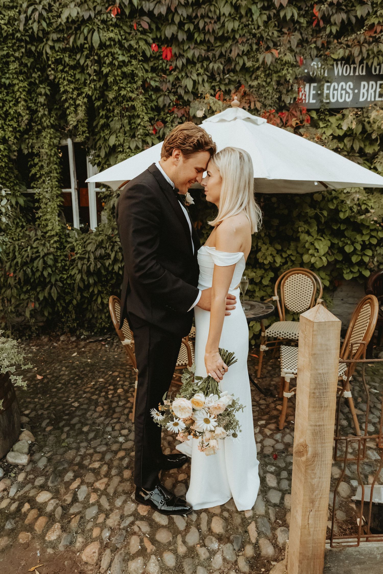 Bride and groom resting foreheads during their couples wedding portraits