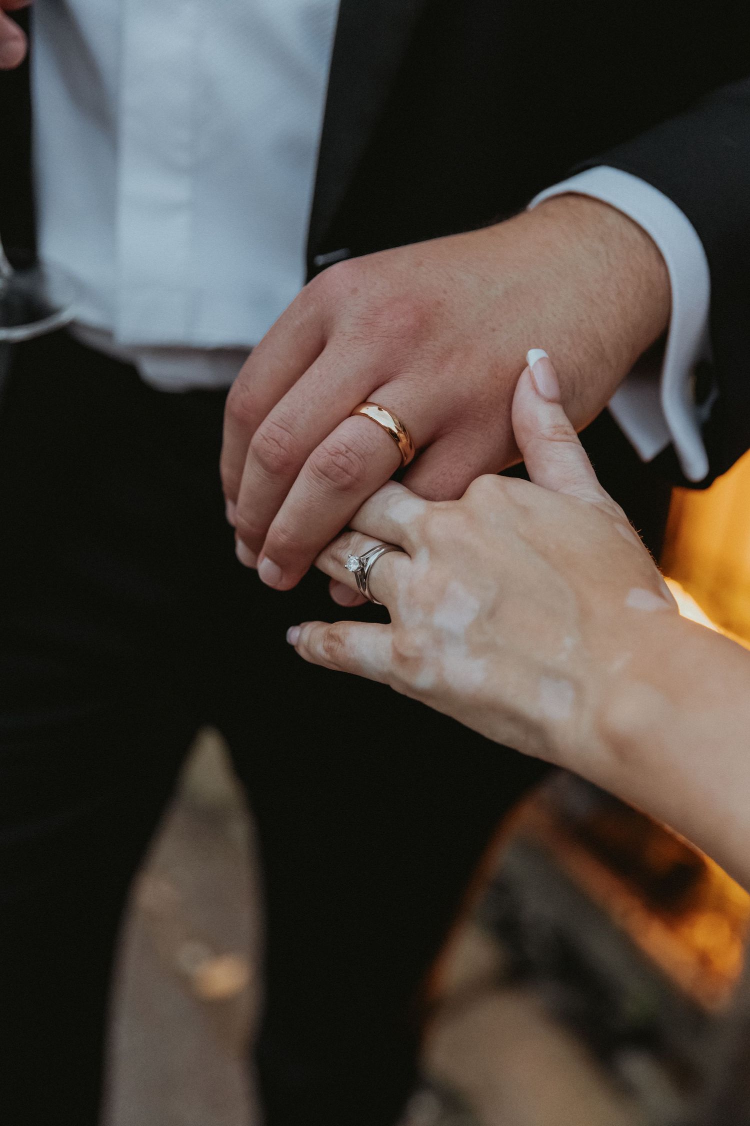 Bride and groom hands showing off new wedding rings