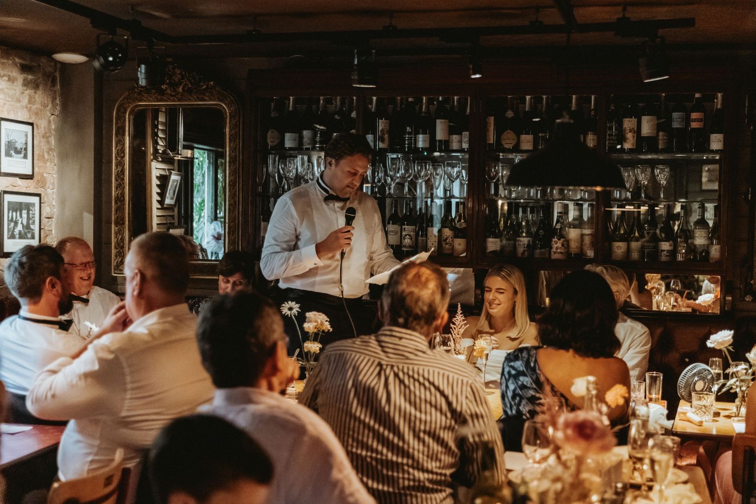 Groom doing speech at wedding amongst diner tables at Roebuck Inn