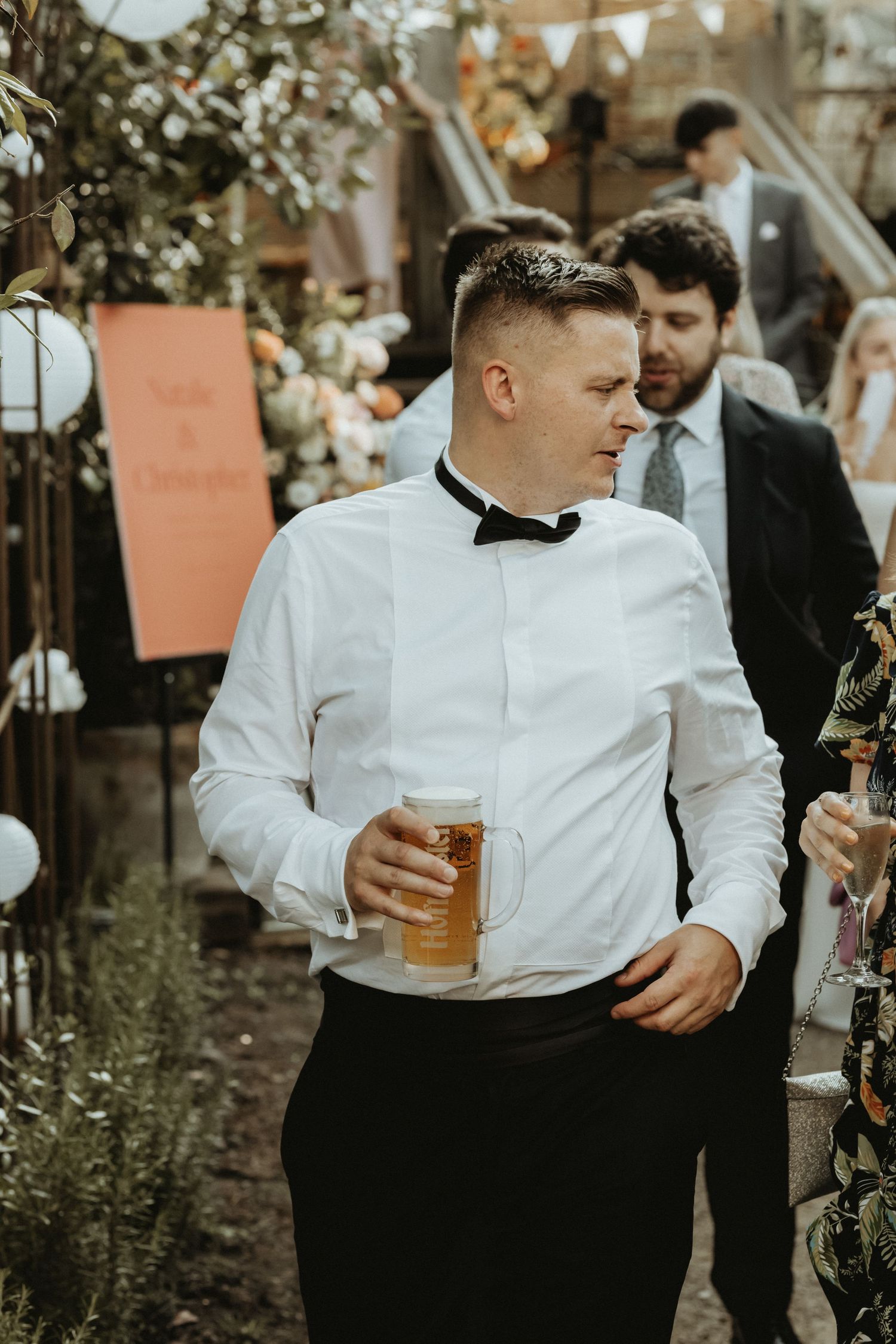 Groomsman walking with pint of beer in hand at The Roebuck Inn
