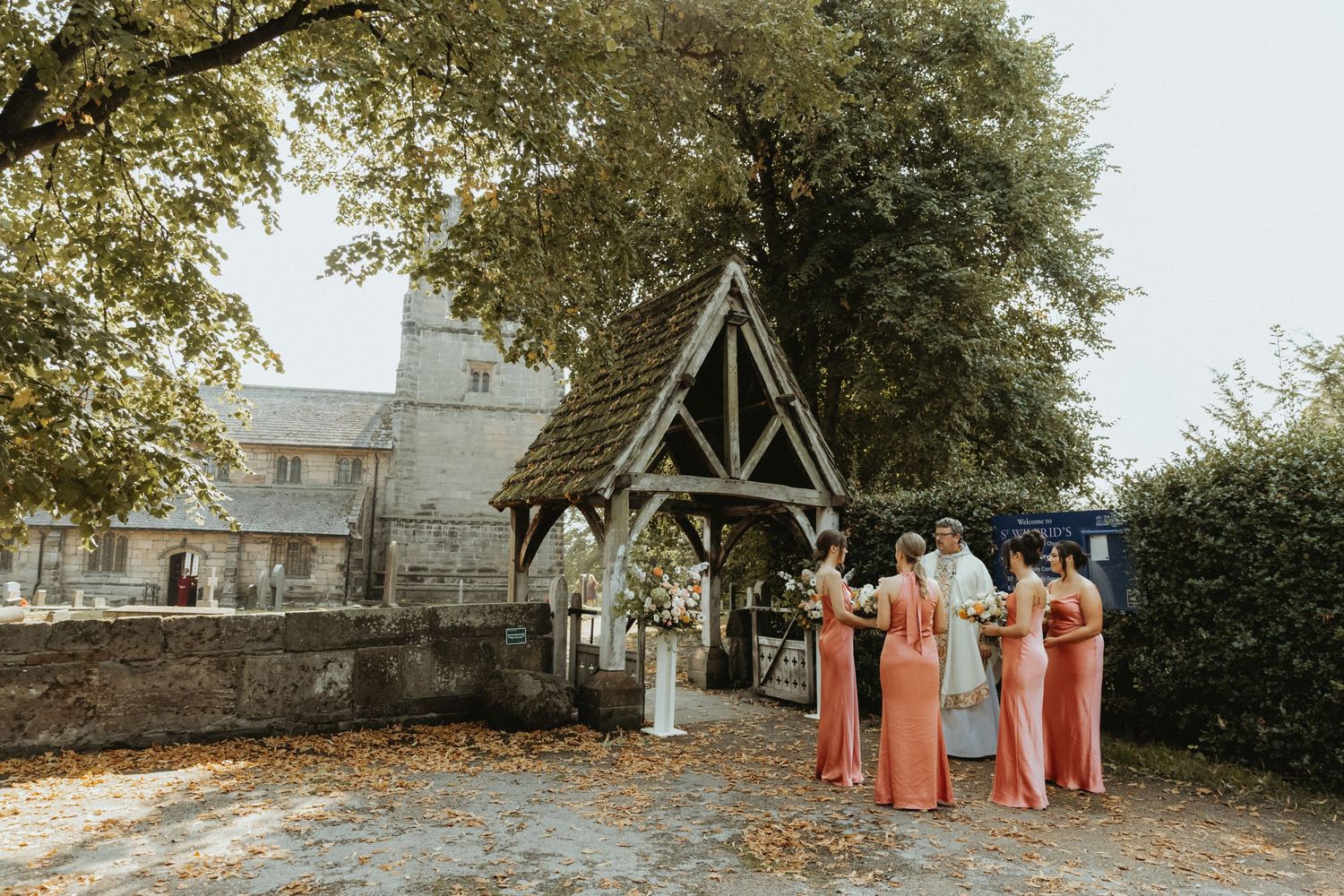 Bridesmaids outside of St Wilfrids church in Mobberley waiting for the bride