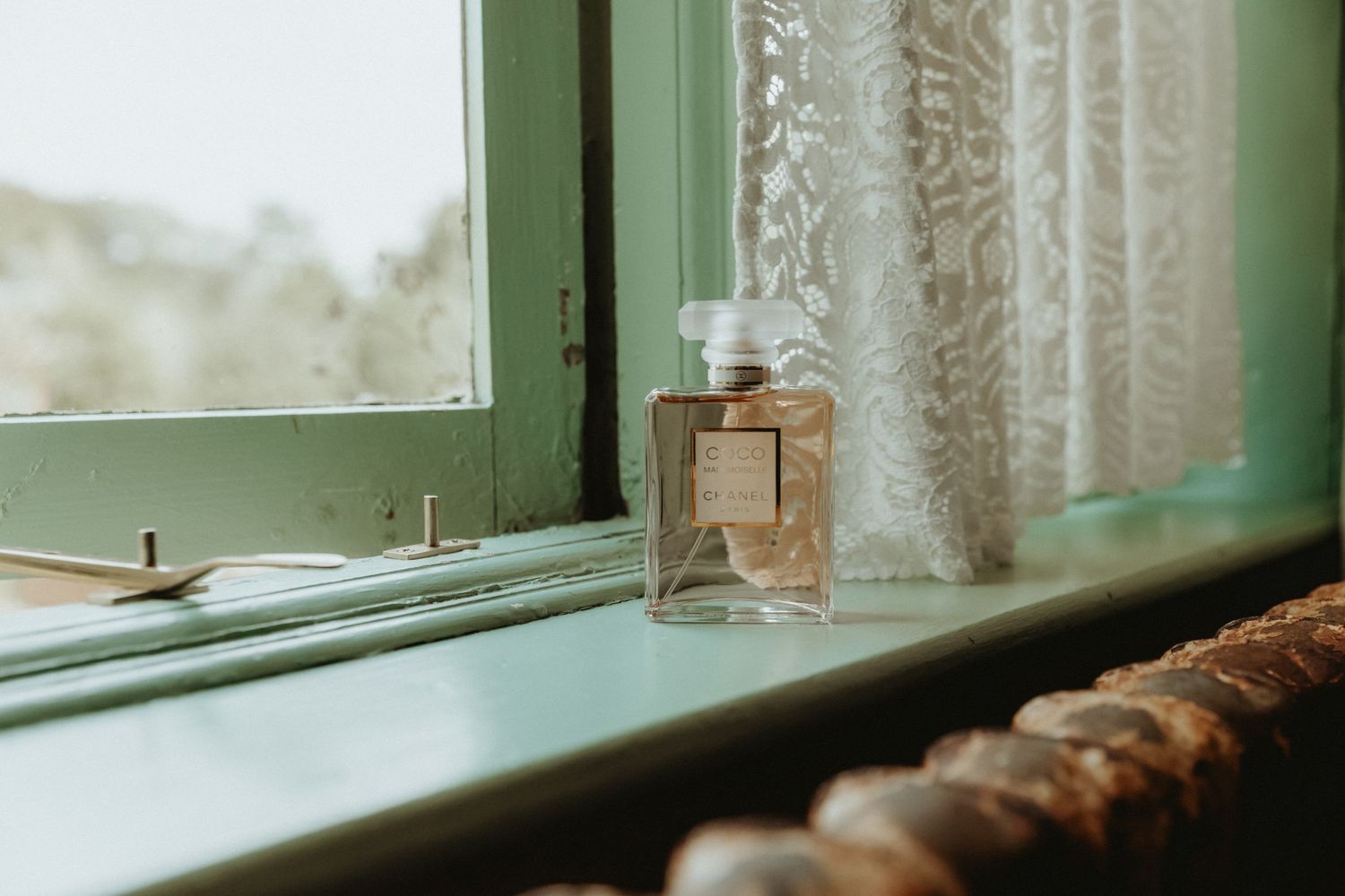 Brides Coco Chanel perfume on window sill at bride prep at The Roebuck Inn