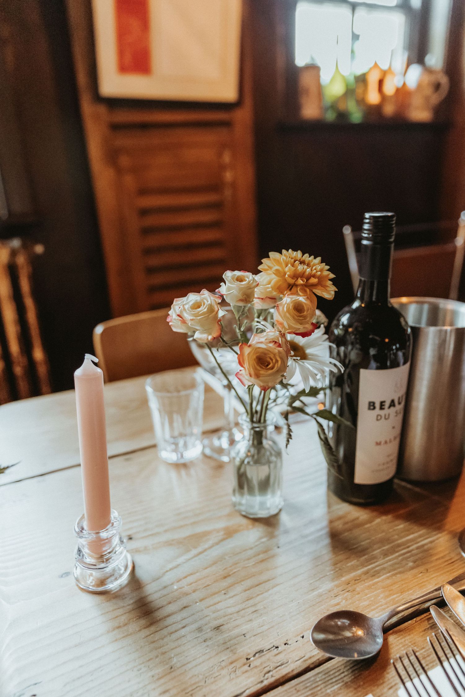Candlestick and small vase of flowers on top at wedding meal The Roebuck Inn
