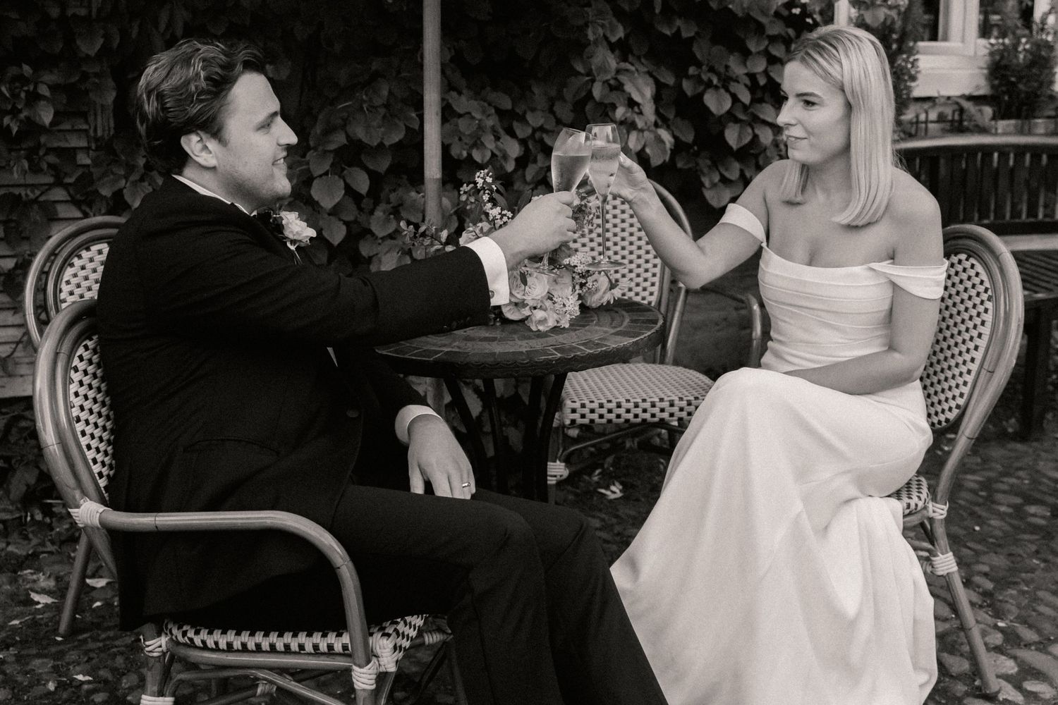 Close up of bride and groom enjoying a drink together on their wedding day