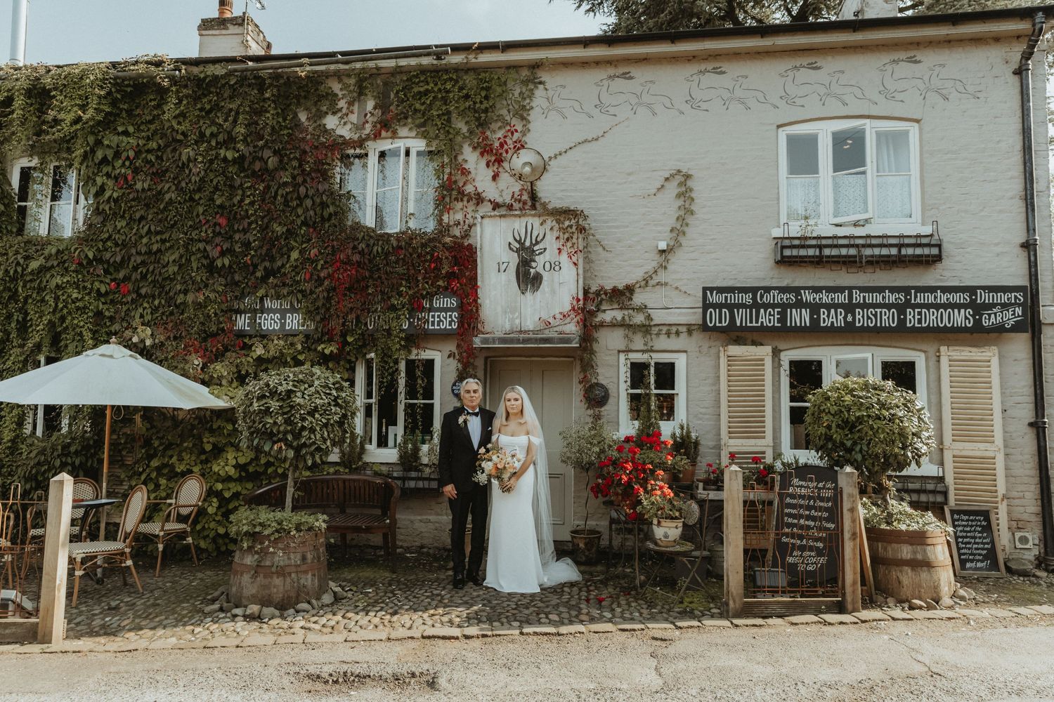 Bride staining with her father on her wedding day outside venue in Cheshire