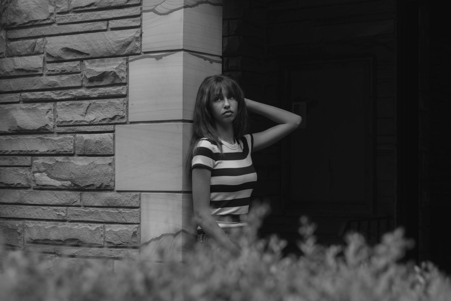 Girl at an old church leaning against the doorway.