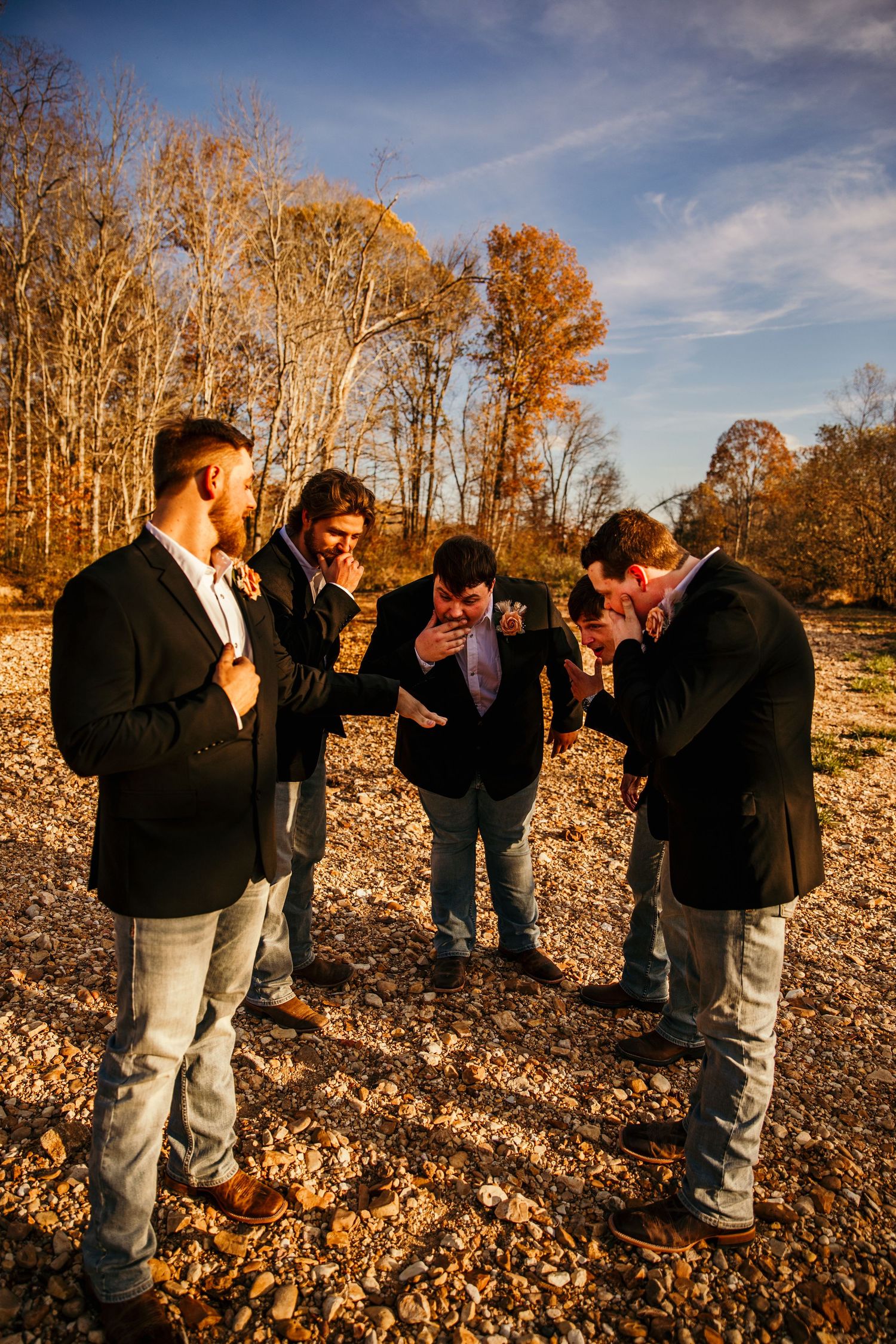 groom and groomsmen portrait with groom showing off wedding band