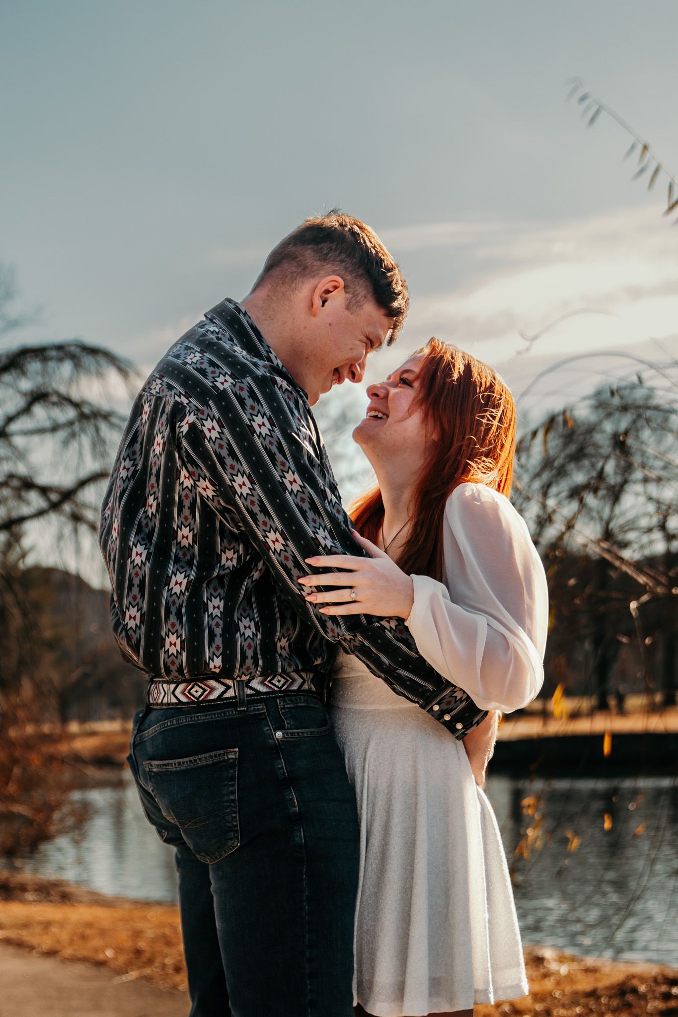 Boy and girl gazing into each other's eyes while soaking in the sunshine.