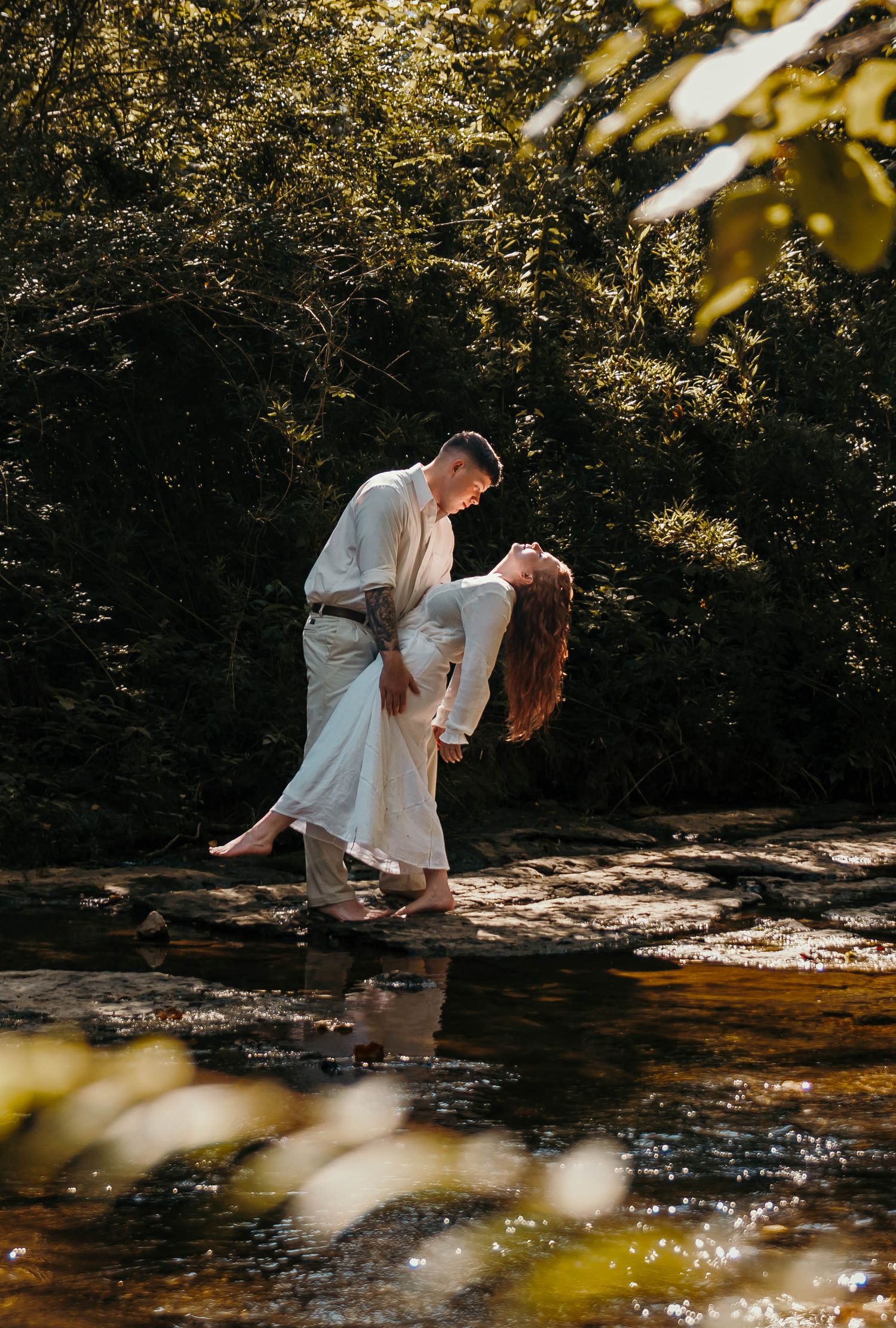 Boy and girl wrapped in each other's embrace while feeling the breeze through their hair.