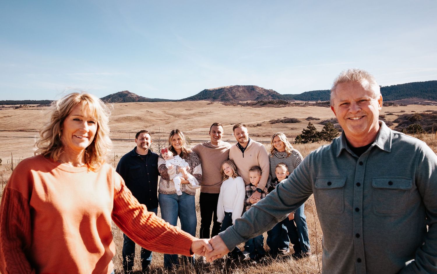 A series of panoramic desert landscape photos showing people gathering outdoors with mountains in the background.