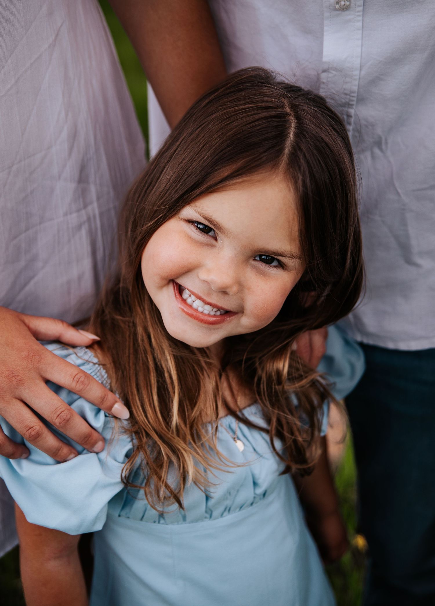 Close up portrait shots create a playful collage showing a child in light blue attire at Ute Valley Park in Colorado Springs