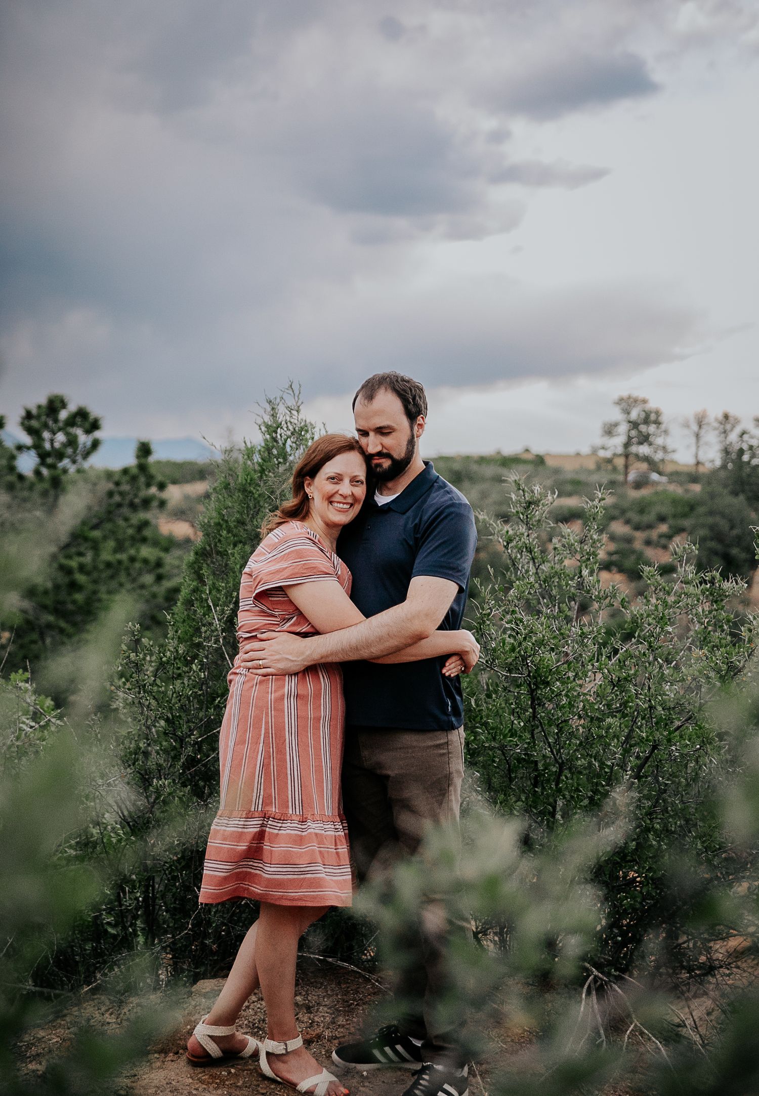 Couple hugging during adoption portfolio photos at Palmer Park in Colorado Springs