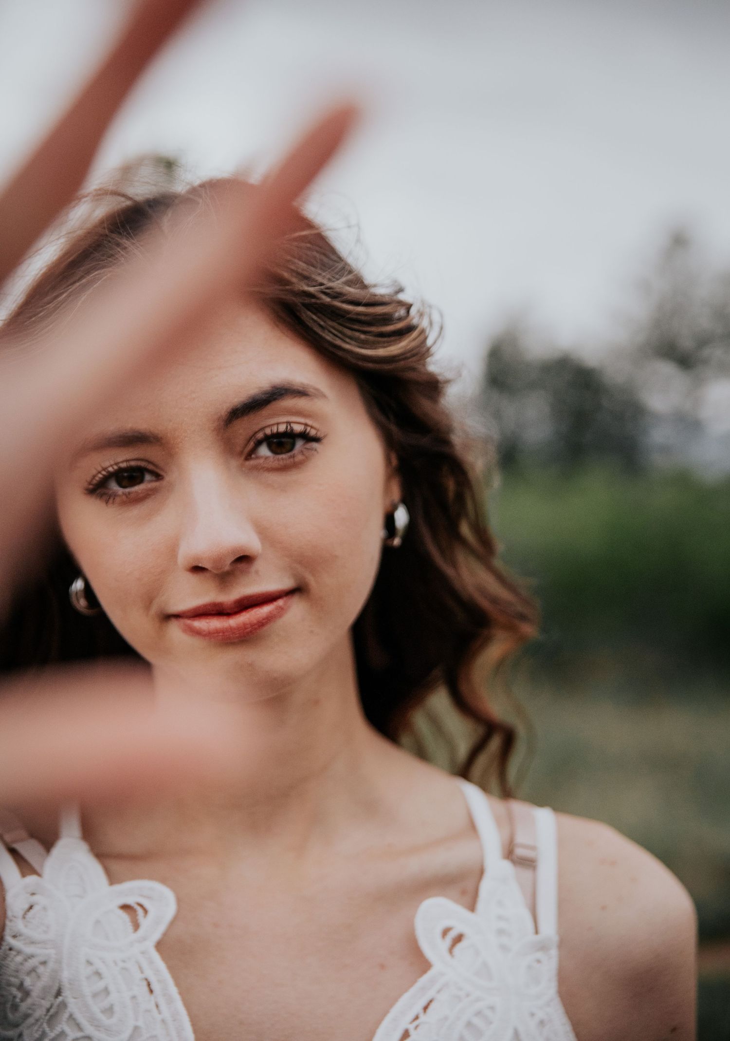 A joyful portrait series showing someone wearing a white lace dress with a soft, dreamy effect.