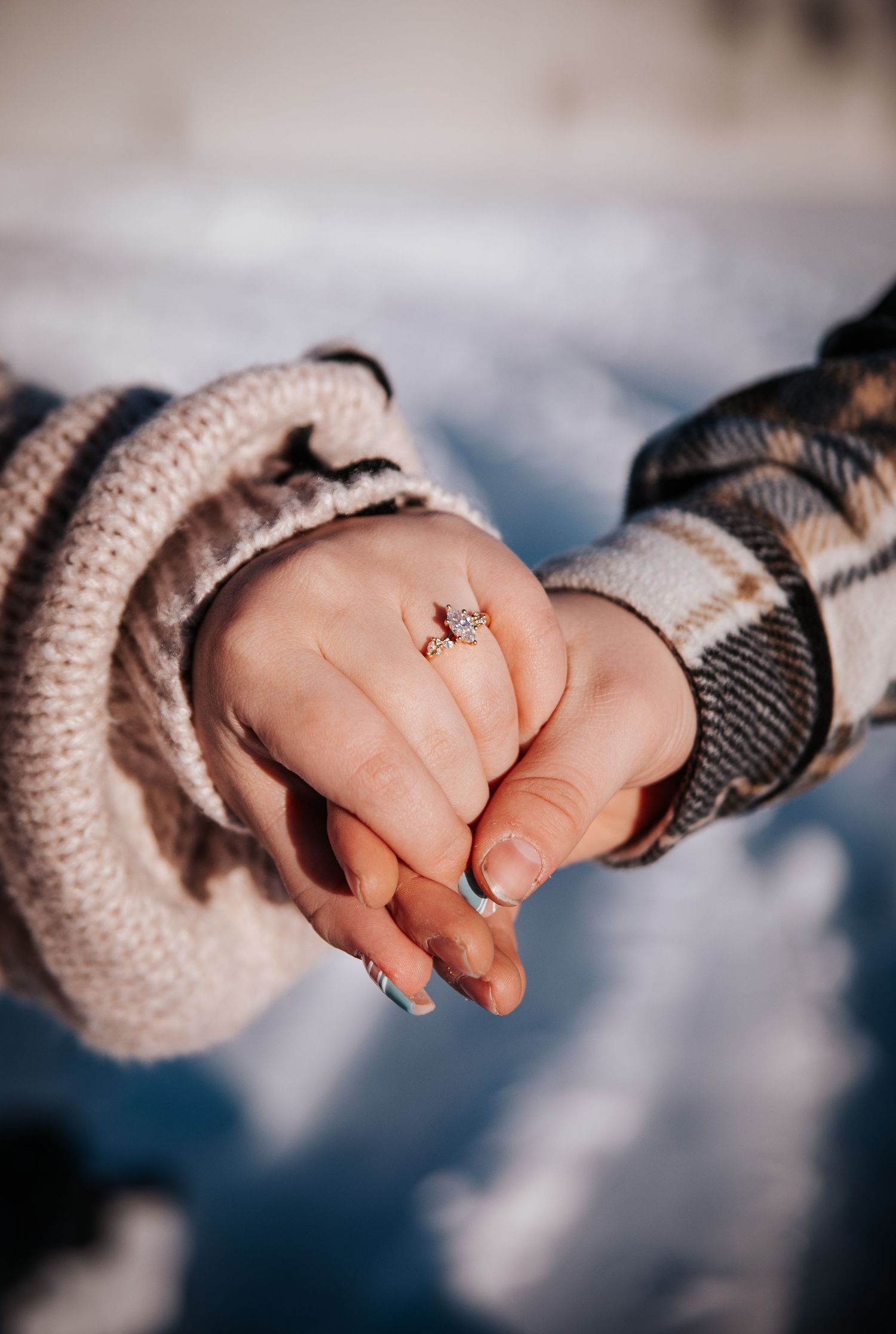 Close up of engagement ring during golden hour in winter engagement photo shoot in Downtown Colorado Springs