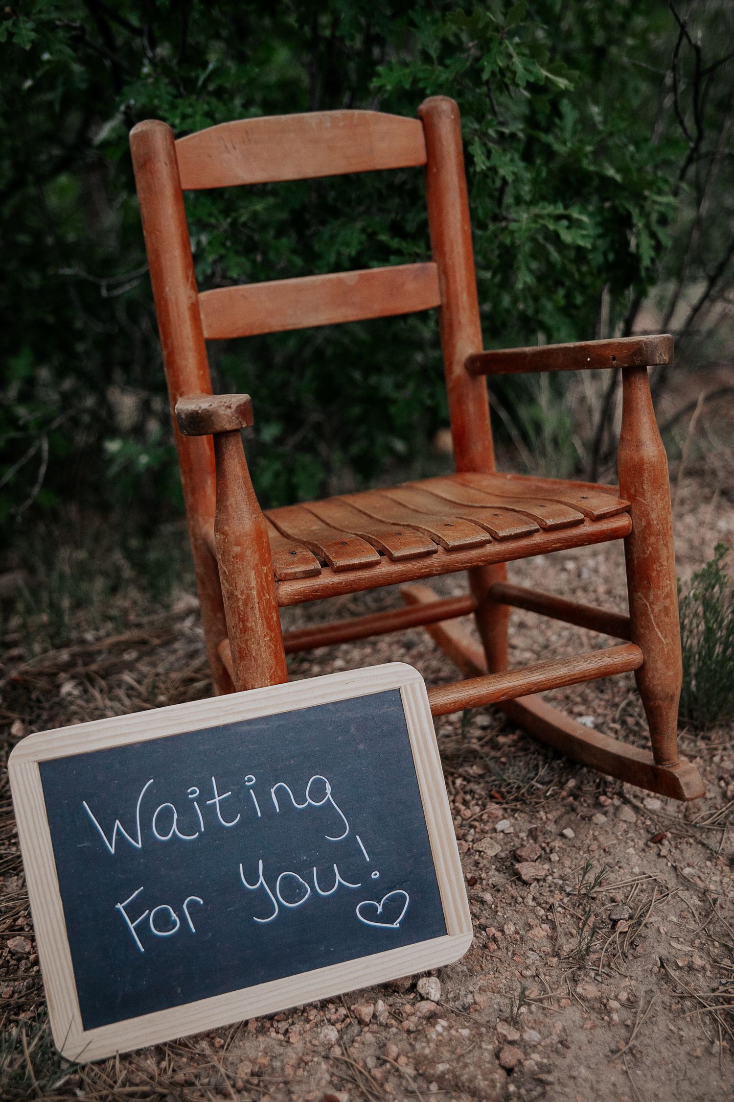 Photo of child's rocking chair and a sign that says 
