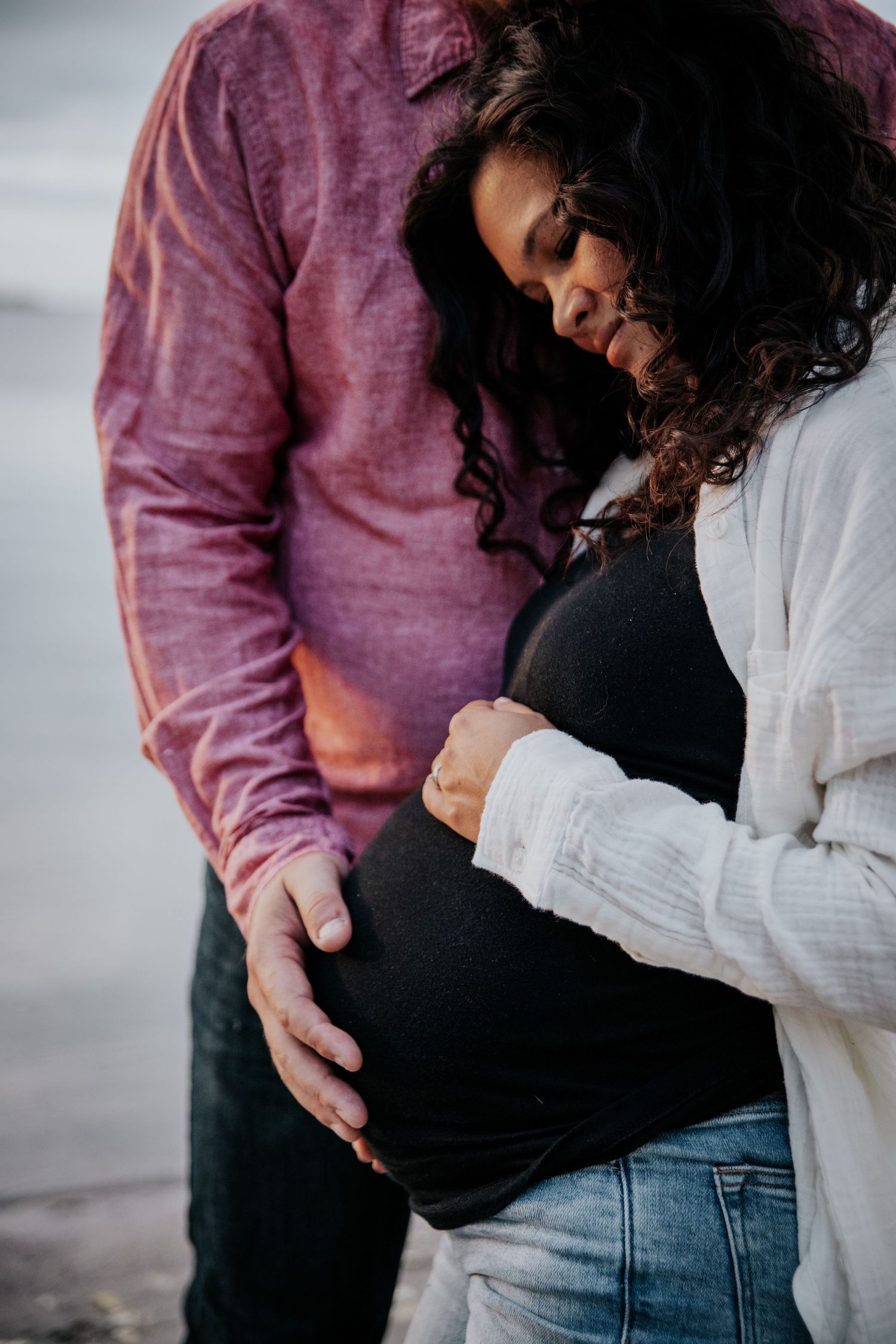 Series of tender moments captured as couple embraces growing baby bump.