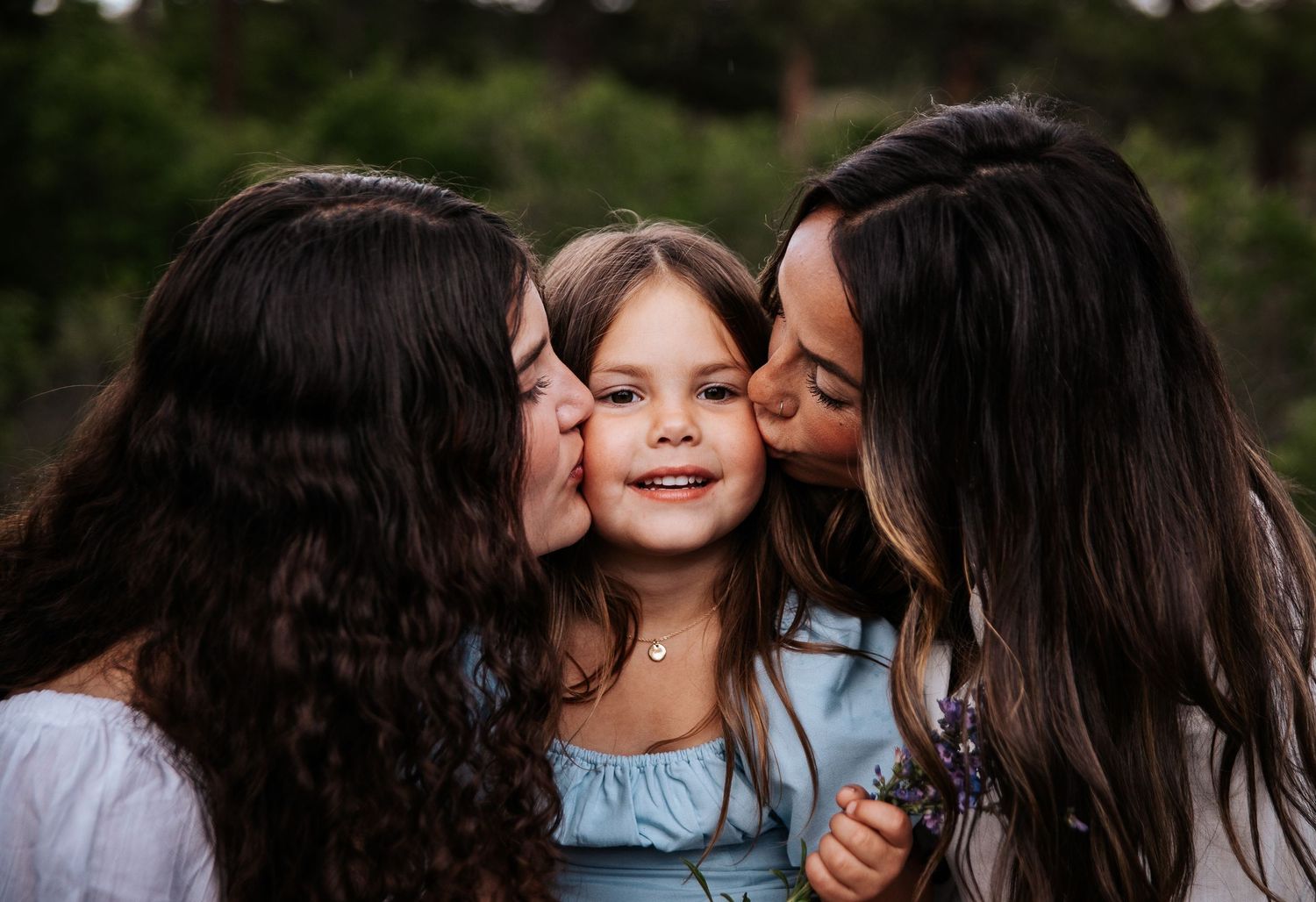 Close up of affectionate family moment outdoors during portrait session at Ute Valley Park in Colorado Springs